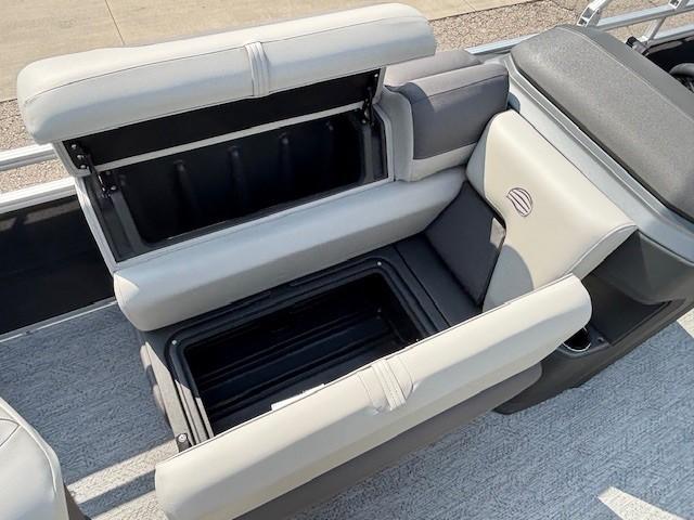 2026 Sun Tracker Fishin' Barge 20 DLX boat seat with open storage compartment.