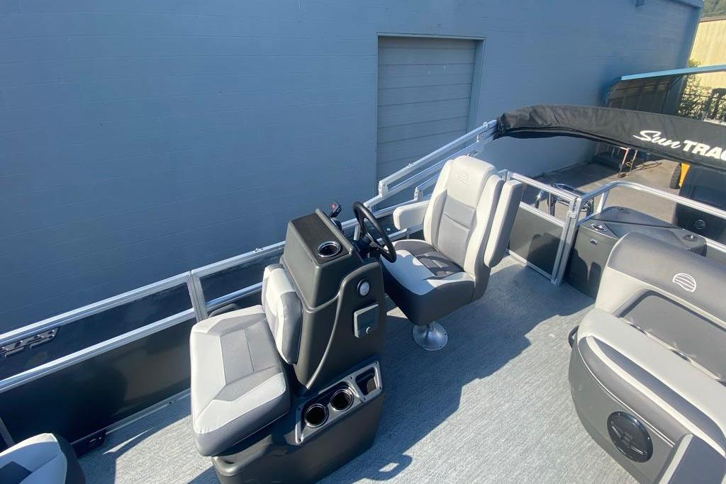 2026 Sun Tracker Bass Buggy 18 DLX pontoon boat interior with steering console and seating.