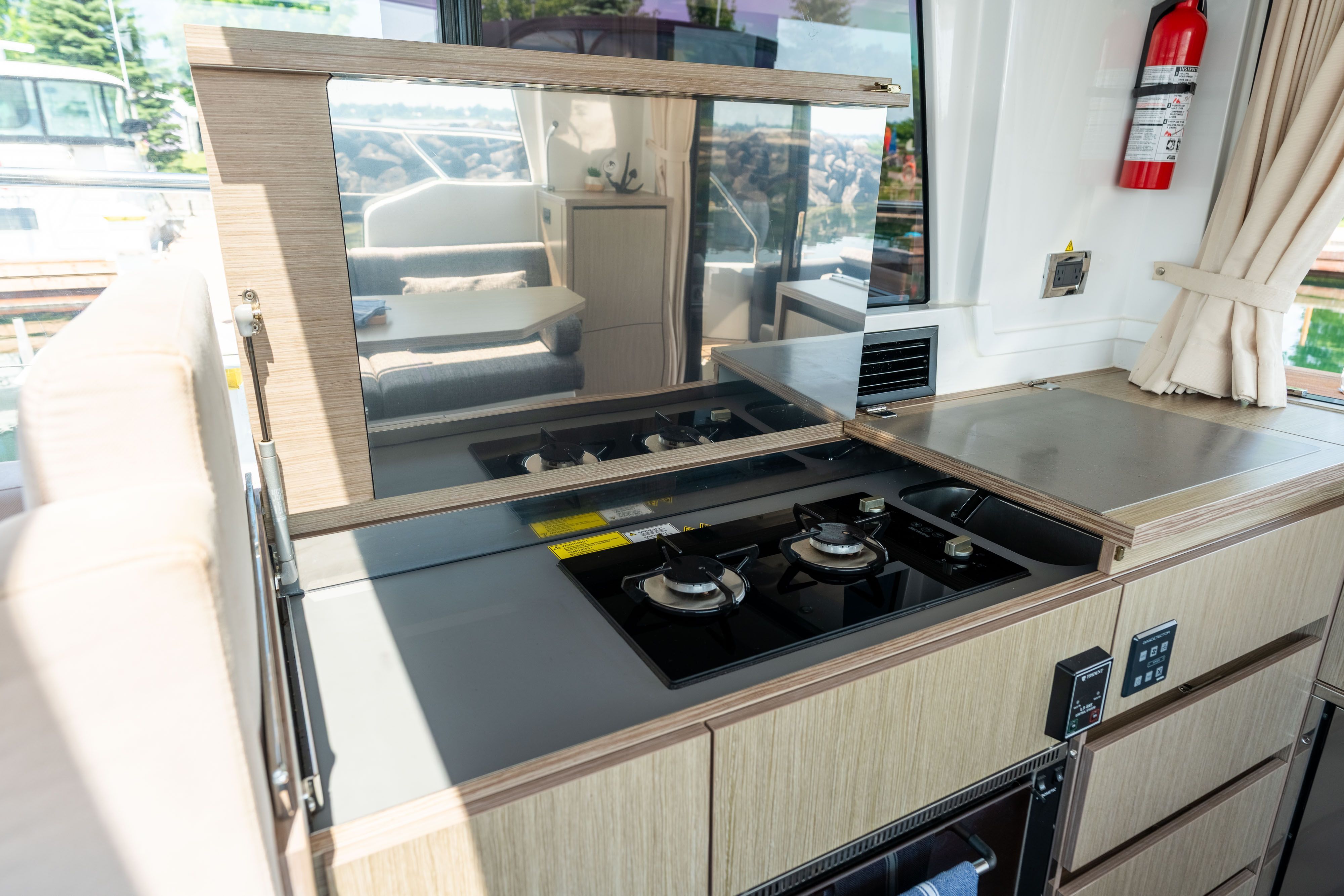 The kitchen on the 2023 Sealine C335V features a modern stove and cabinetry.