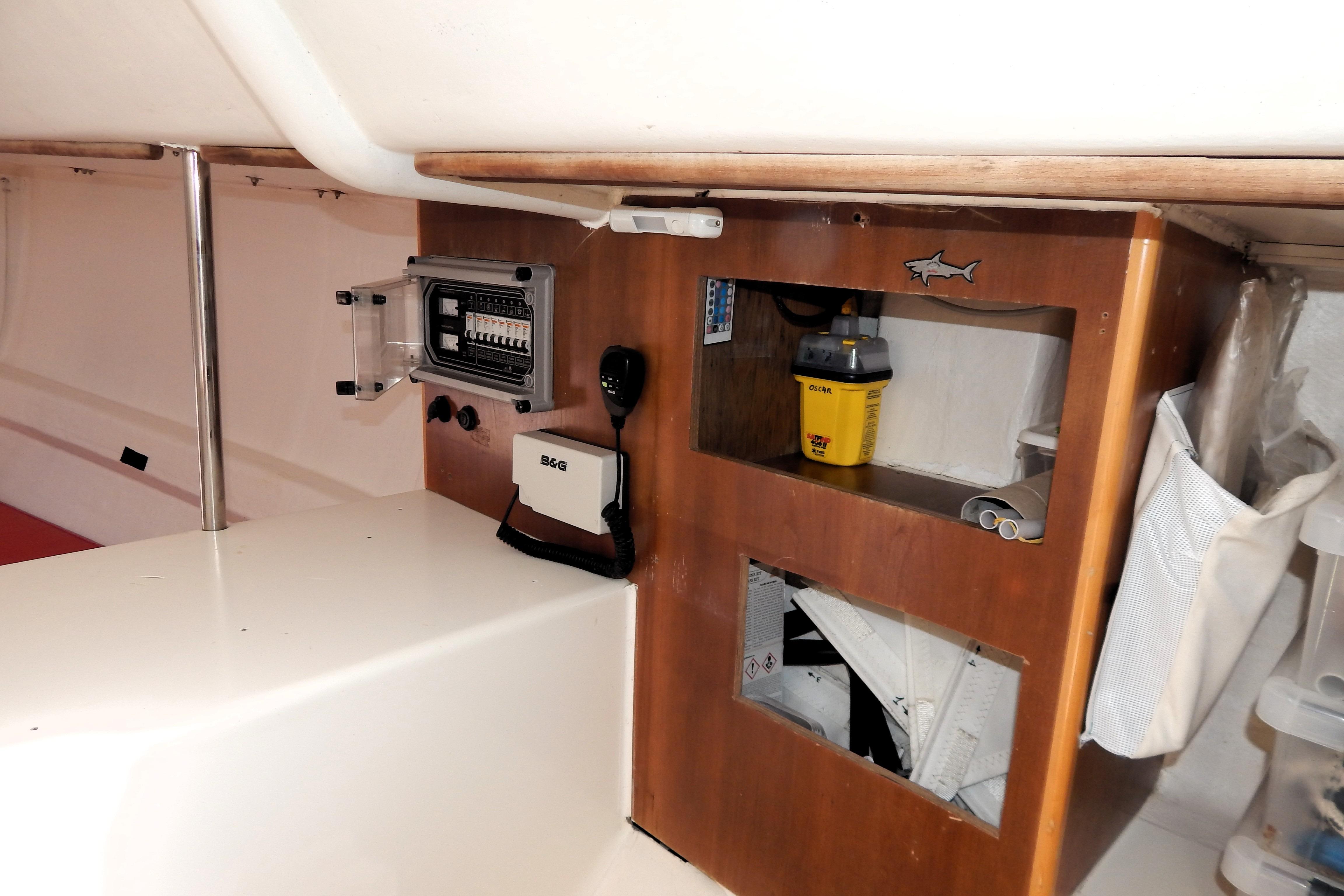 Interior of 1998 Maxi Dolphin Giro 34 yacht with control panel and storage.