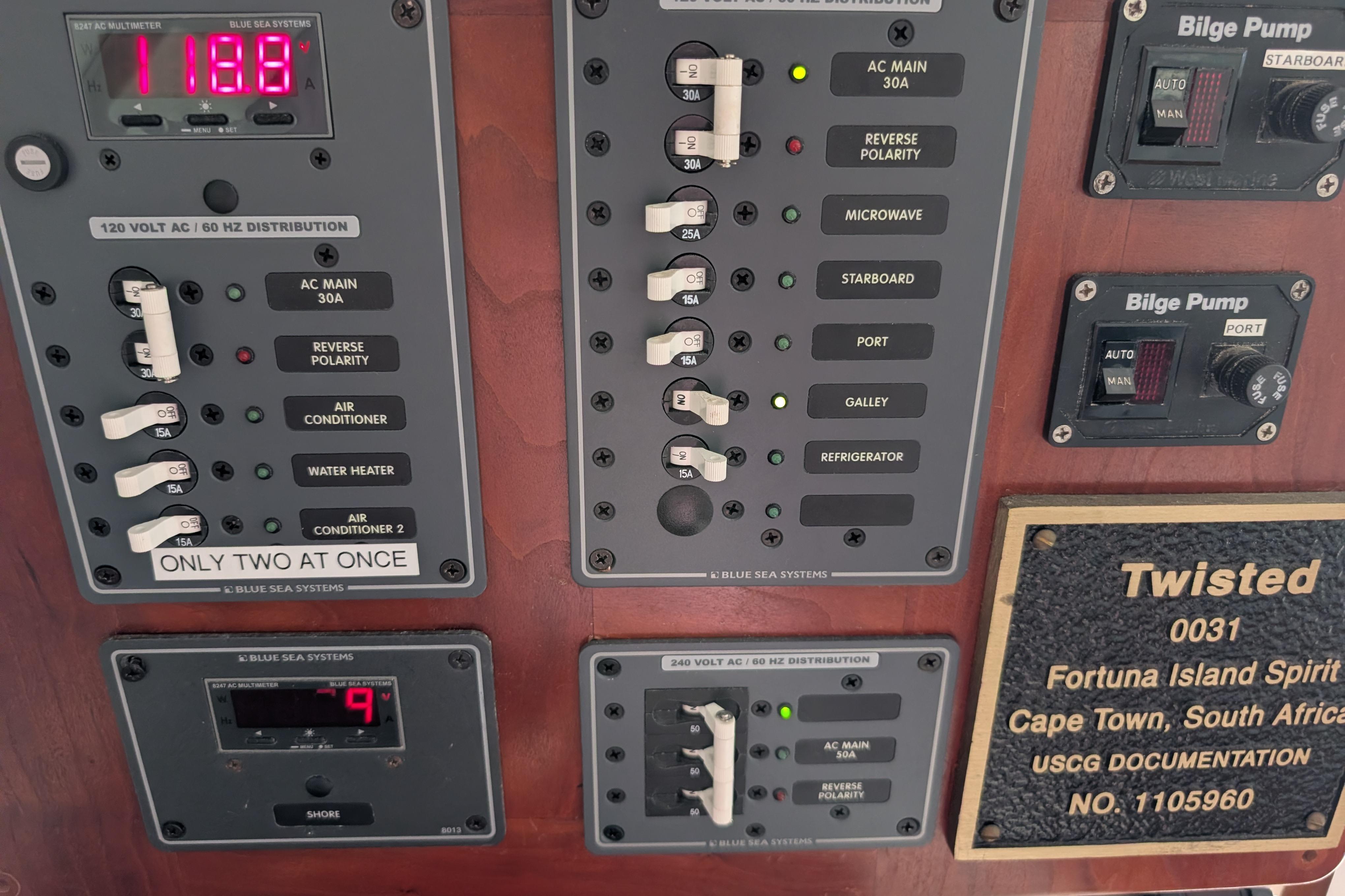 Electrical control panel on 1999 Island Spirit 37 yacht, featuring switches and bilge pump controls.