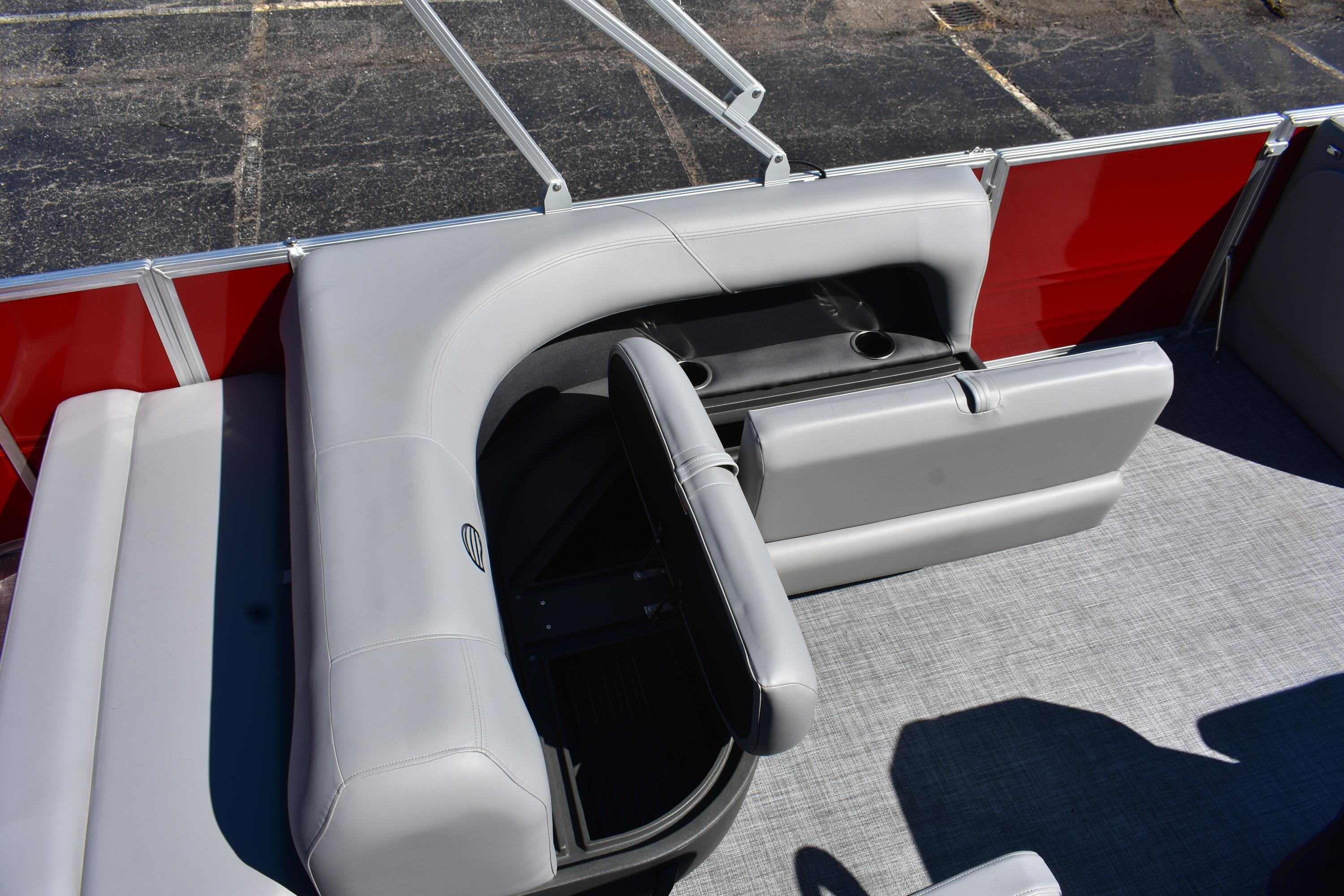 2026 Sun Tracker Party Barge 18 DLX interior with gray seating and cup holders.