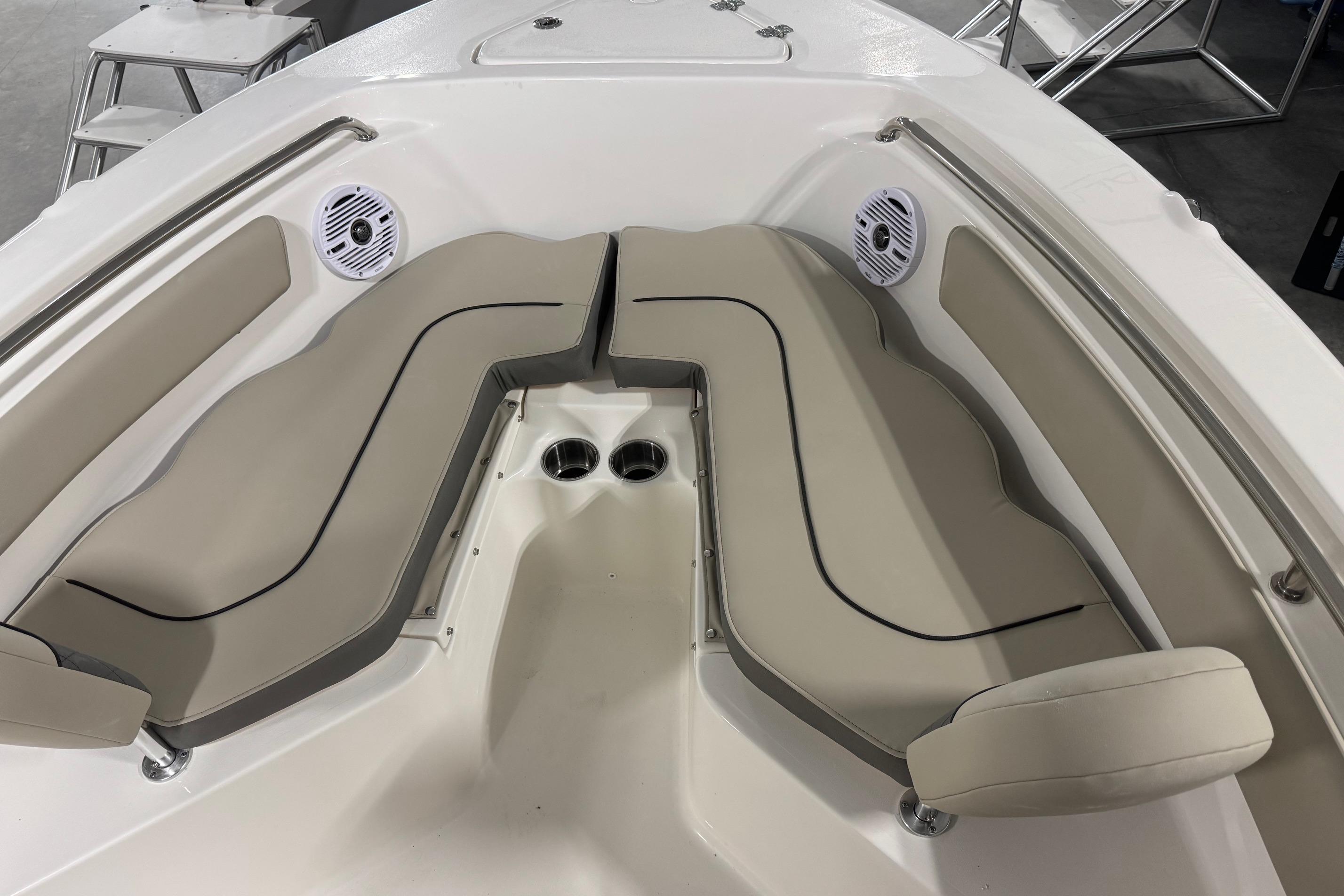 2026 Key West 203 FS boat interior with beige seating and built-in speakers.