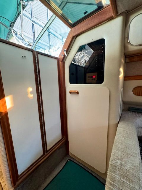 Interior of the 1992 Sea Ray 290 Sundancer with wood accents and upholstery.