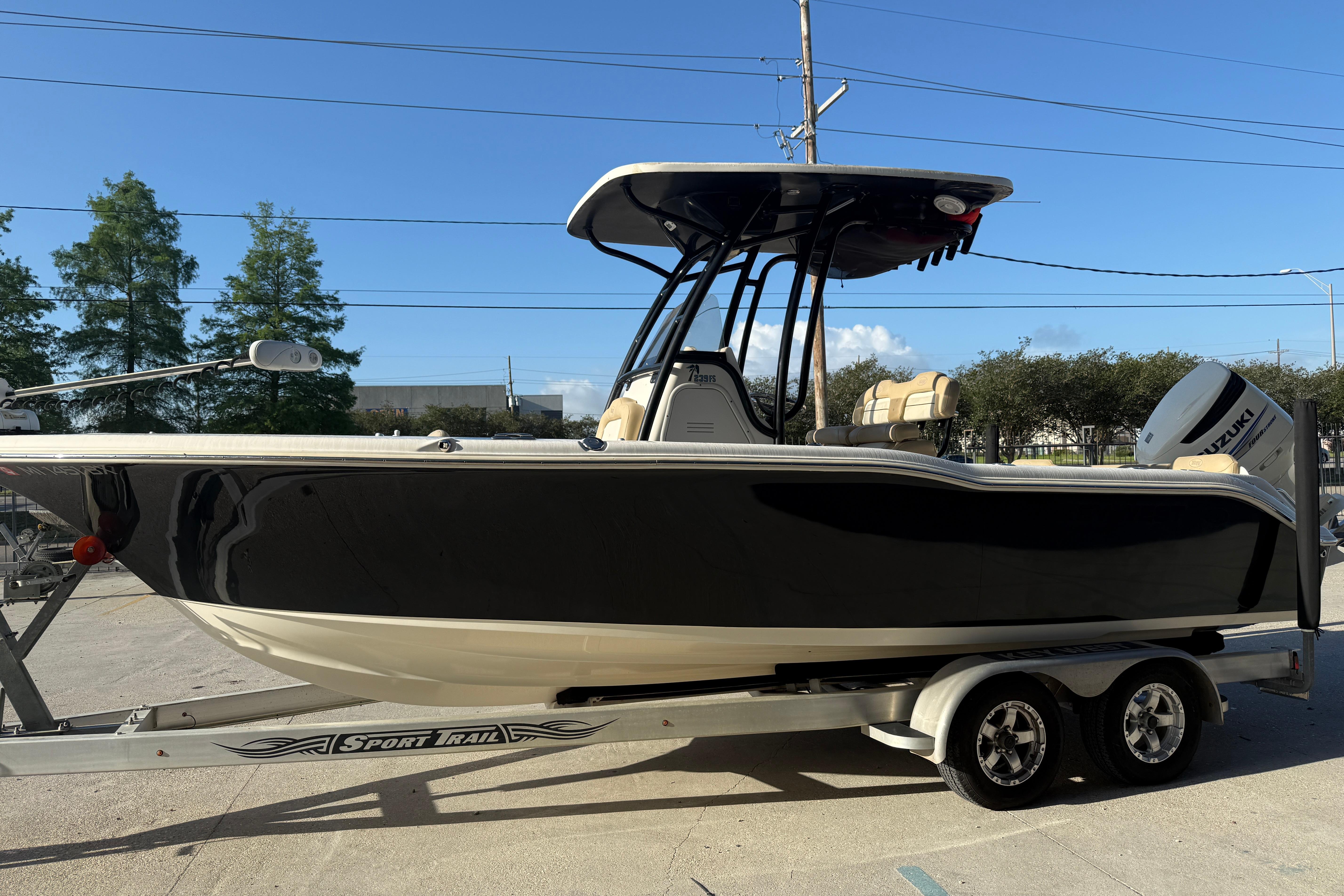 2016 Key West 239 FS boat on trailer, black hull, sunny day.