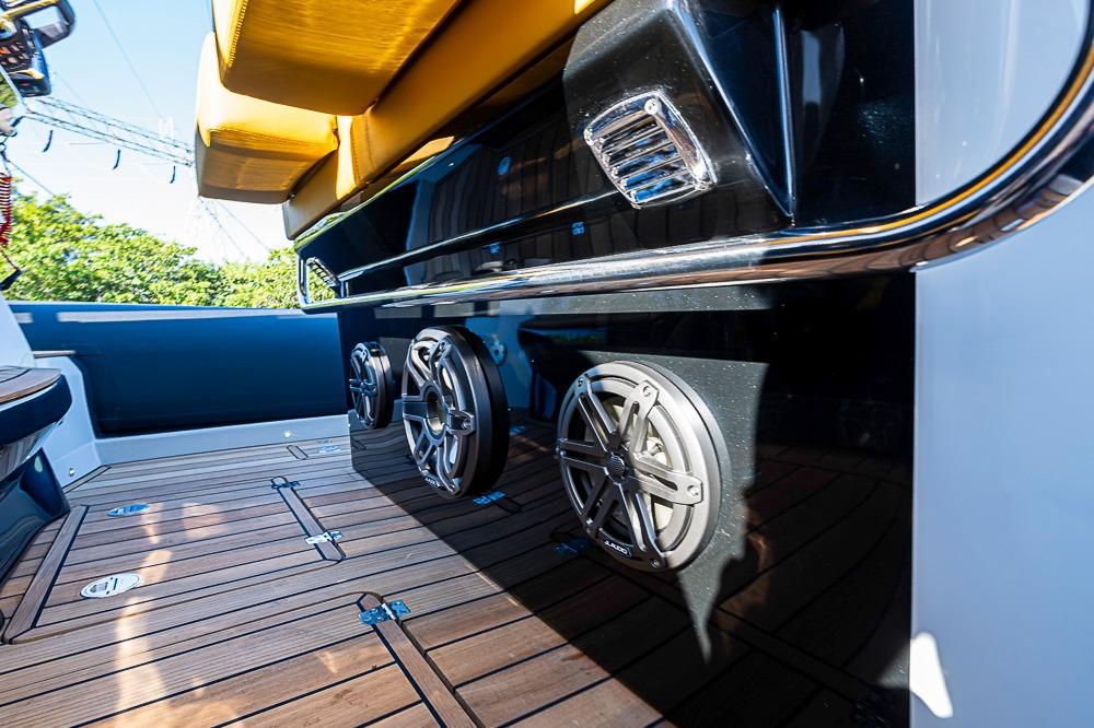 2025 SACS Strider 11 boat interior with teak flooring and premium audio speakers.