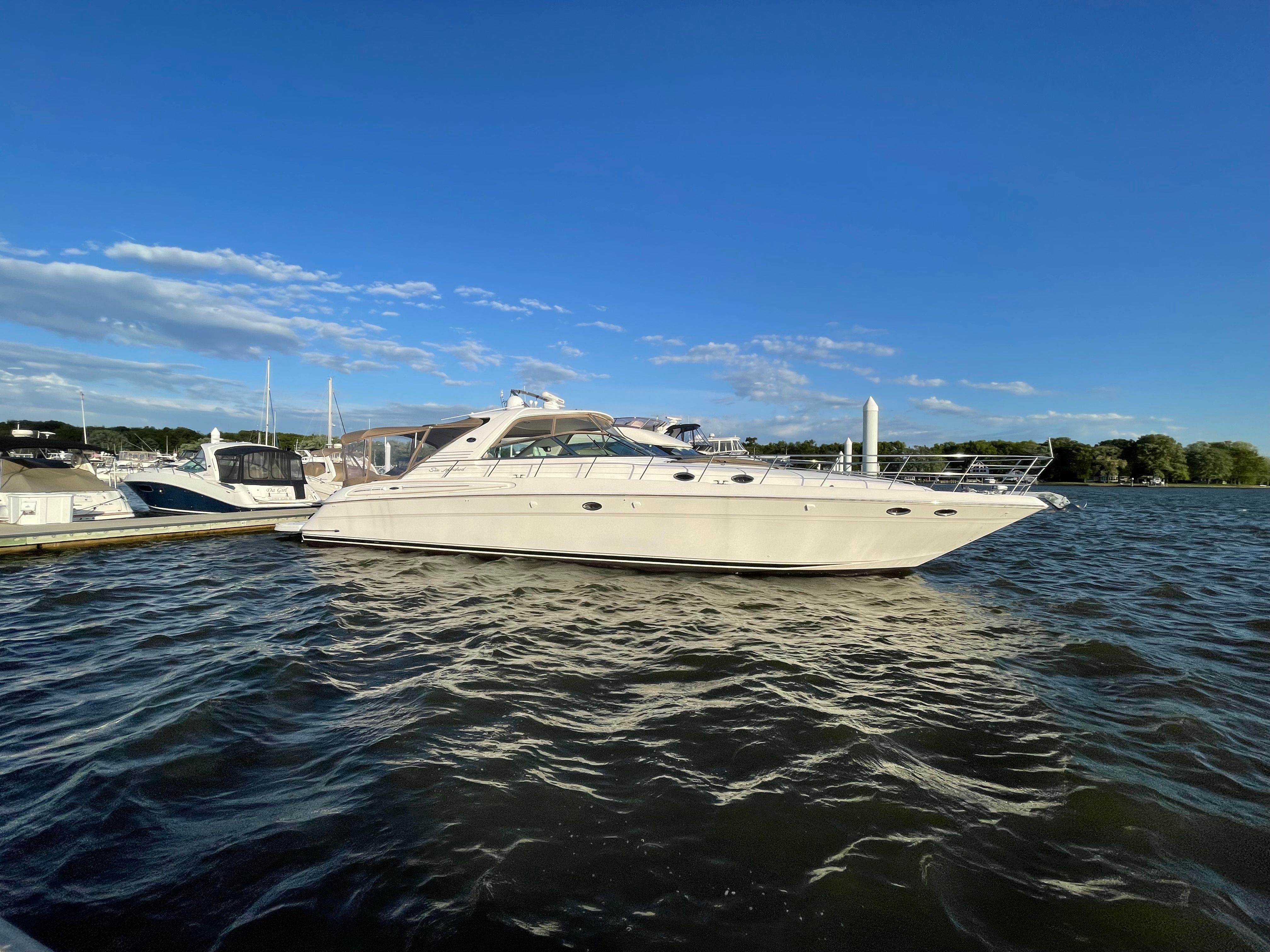 2003 Sea Ray S600 Sunsport on water, featuring sleek design and spacious deck.