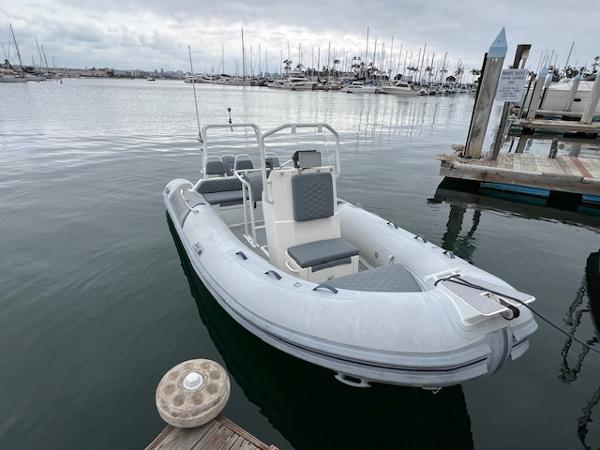 2017 Highfield OM 500 inflatable boat docked at a marina.