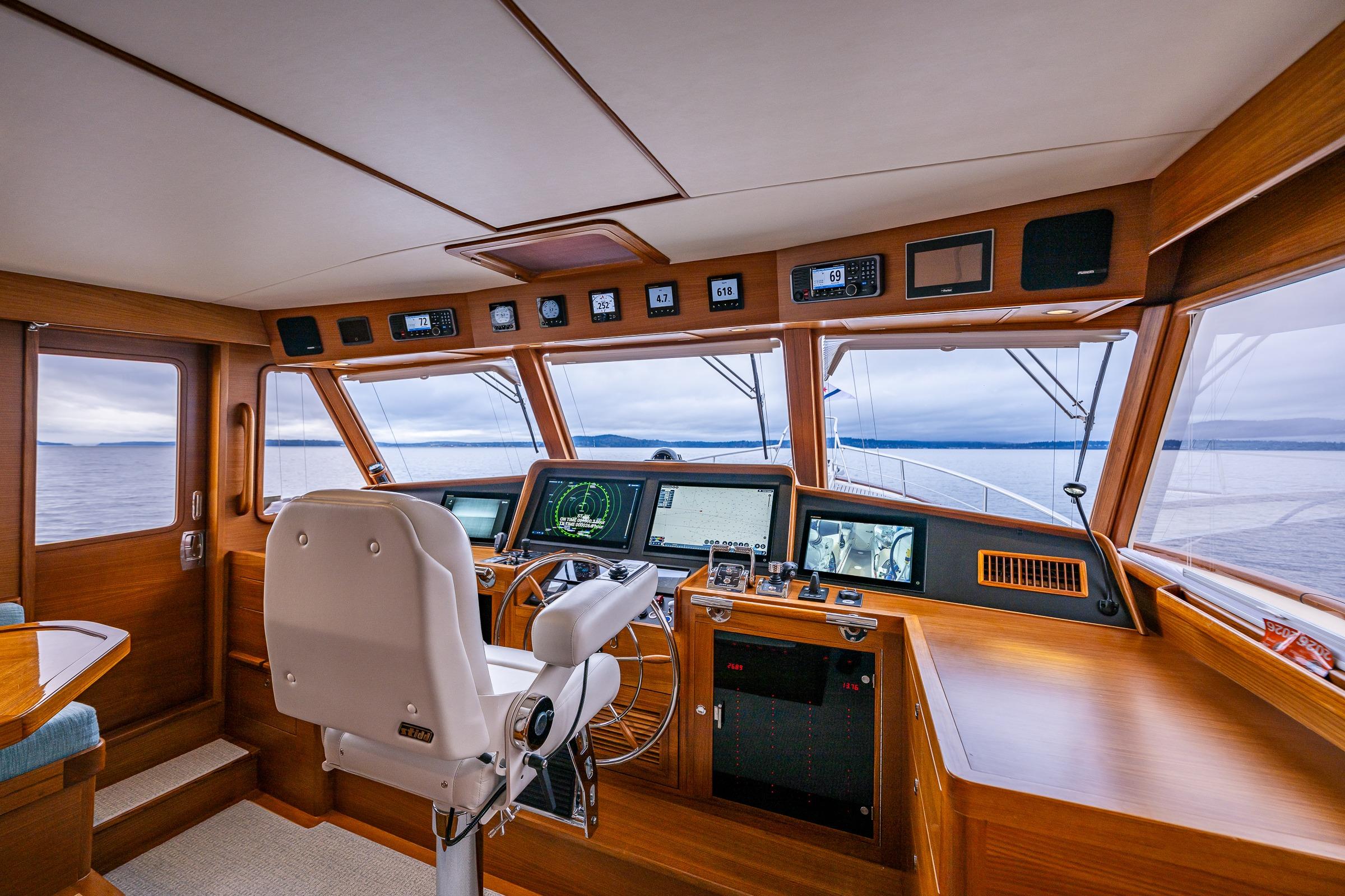Luxurious 2026 Fleming 55 Pilothouse yacht interior with advanced navigation systems and panoramic sea views.