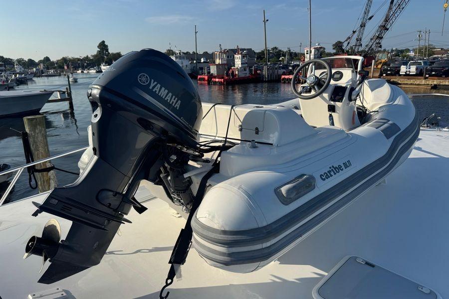 Inflatable boat with Yamaha motor on 2002 Viking 61 Enclosed Bridge yacht.