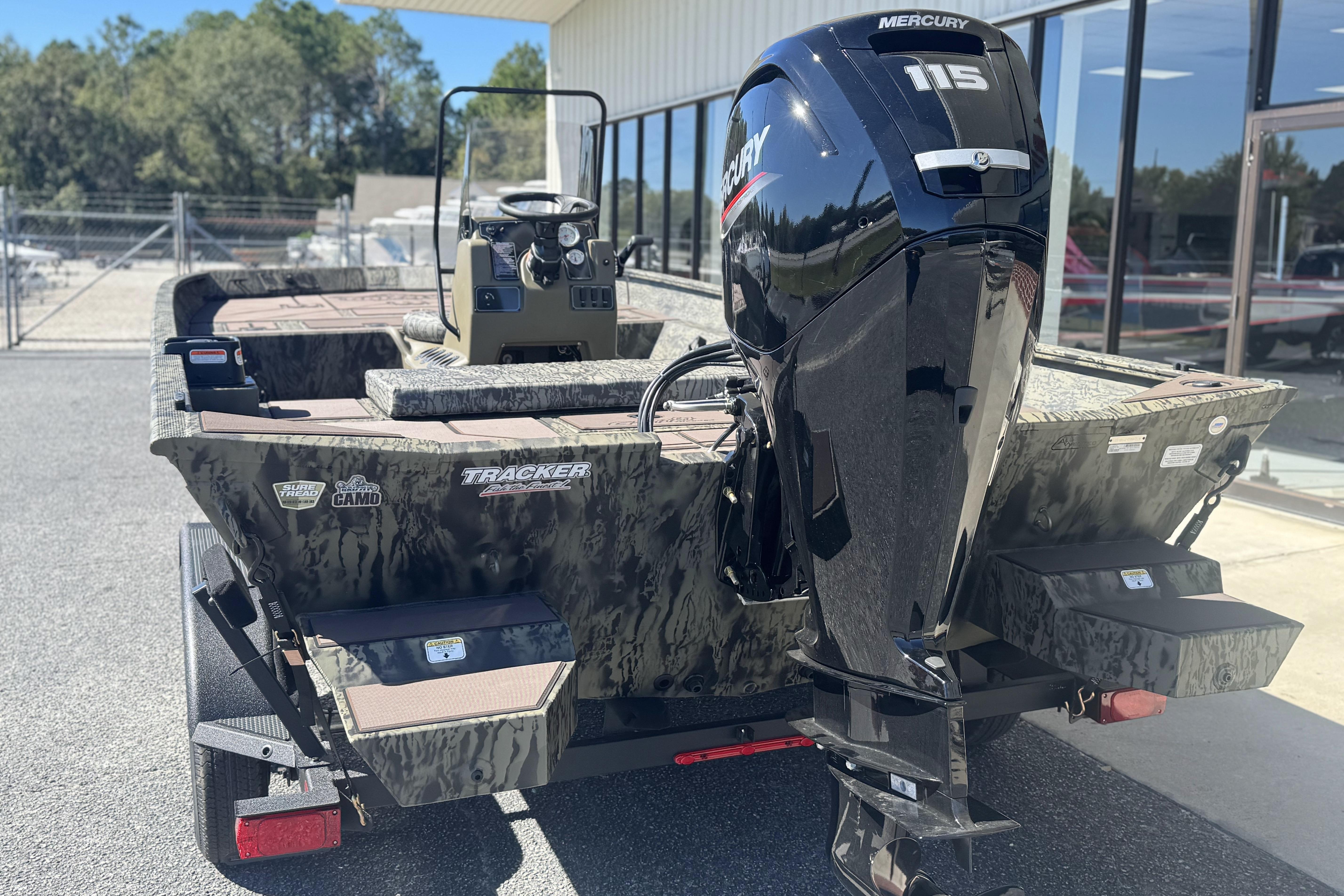 2026 Tracker Grizzly 2072 CC boat with Mercury 115 engine, parked outdoors.