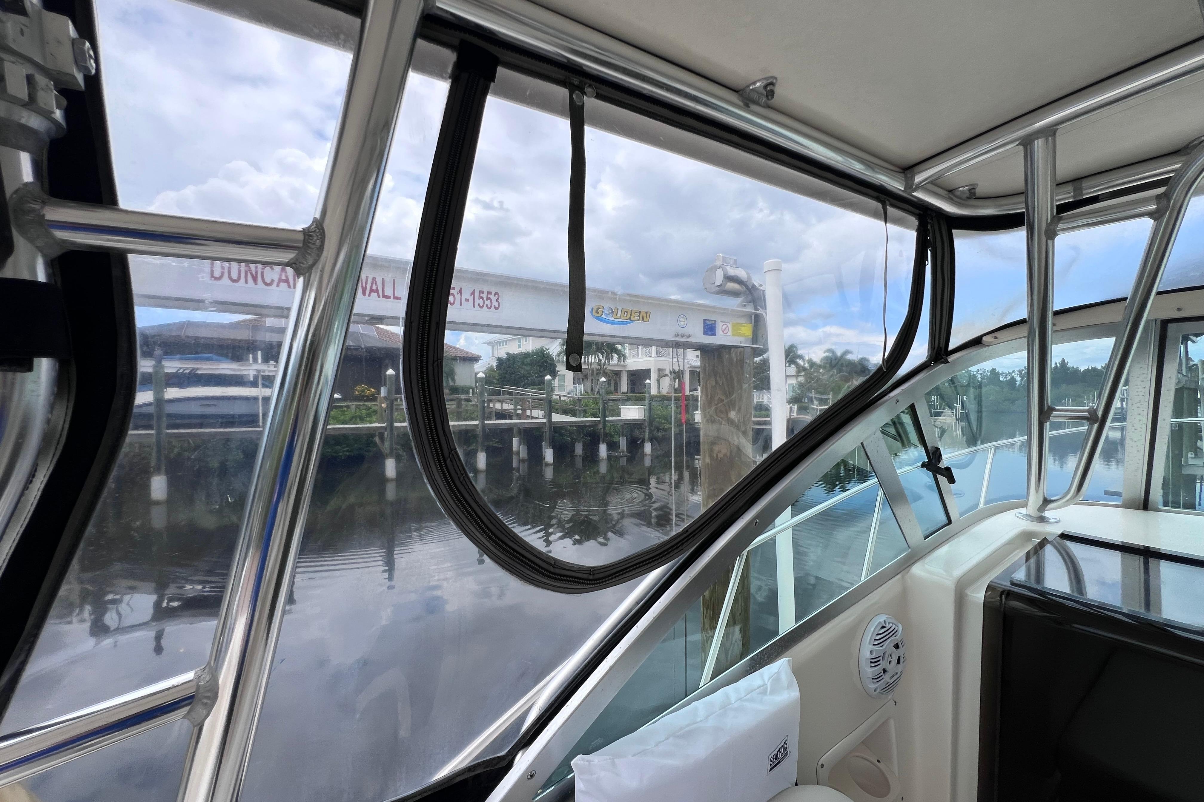 2005 Pursuit 3070 Offshore boat interior with marina view through windows.