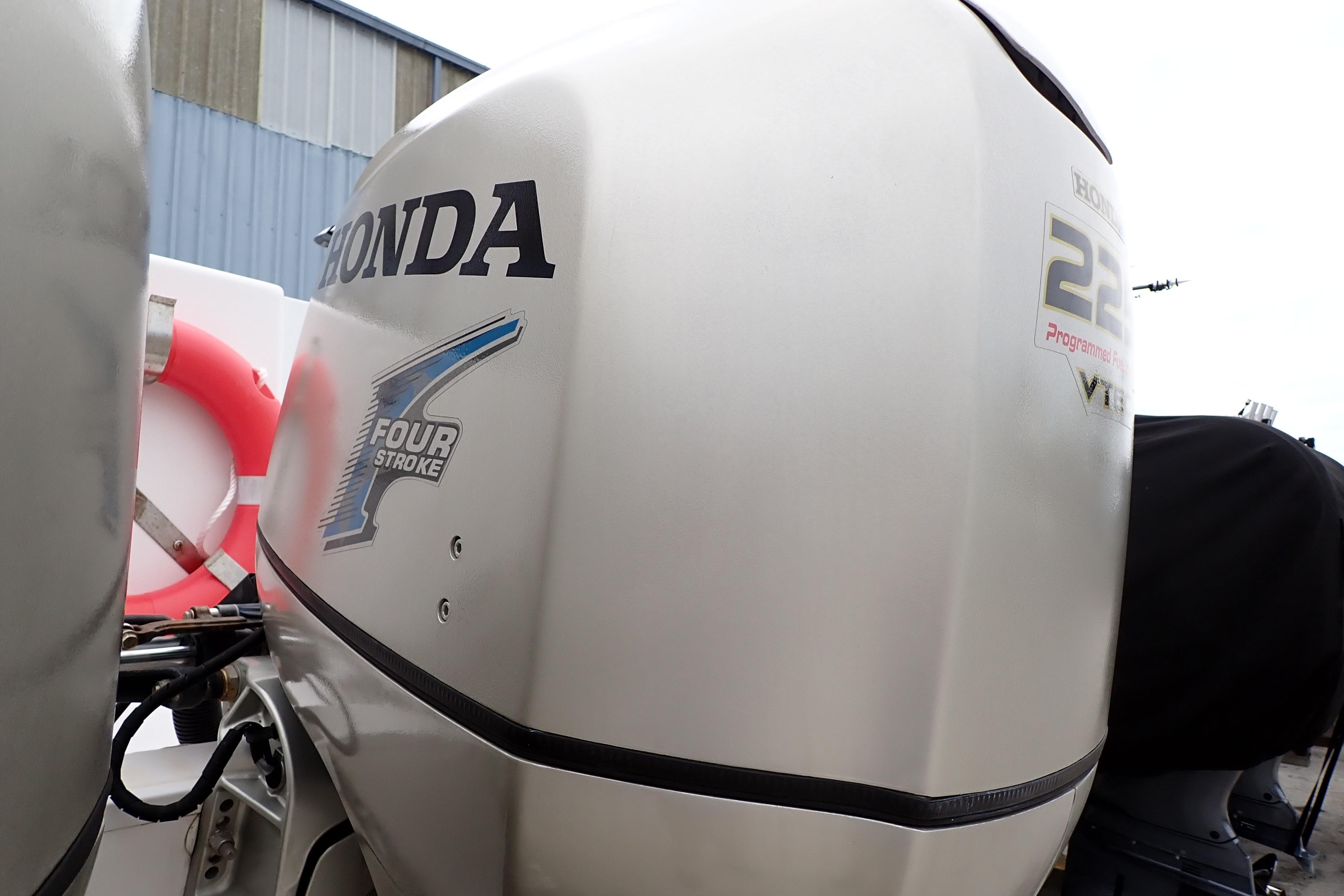 2002 Pro-Line 33 WA boat with Honda 225 four-stroke outboard engine.