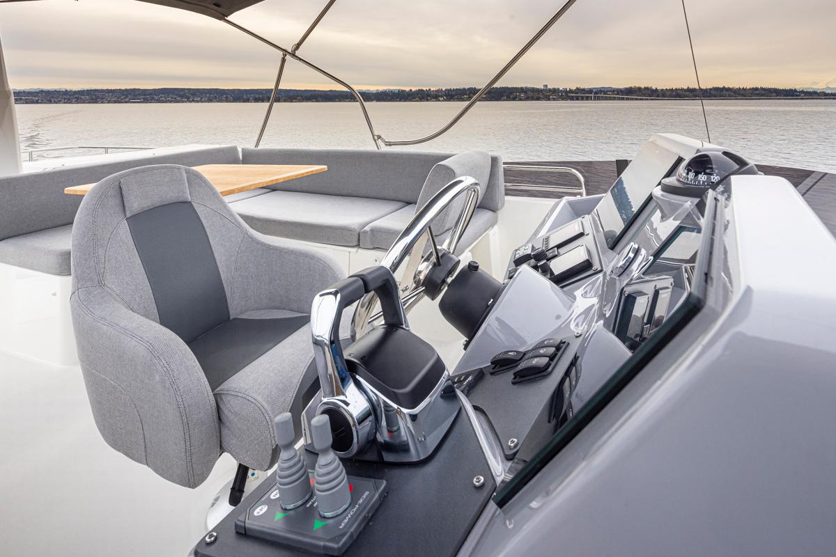 2026 Beneteau Swift Trawler 41 Flybridge helm with modern controls and seating.