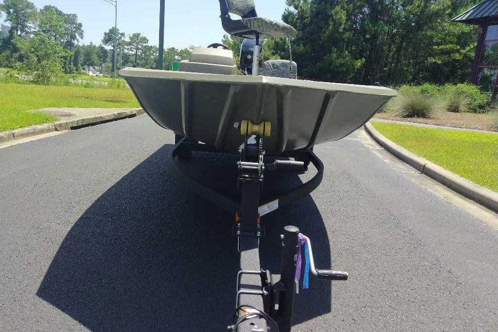 2026 Tracker Grizzly 1754 SC boat on trailer, parked on a sunny road.