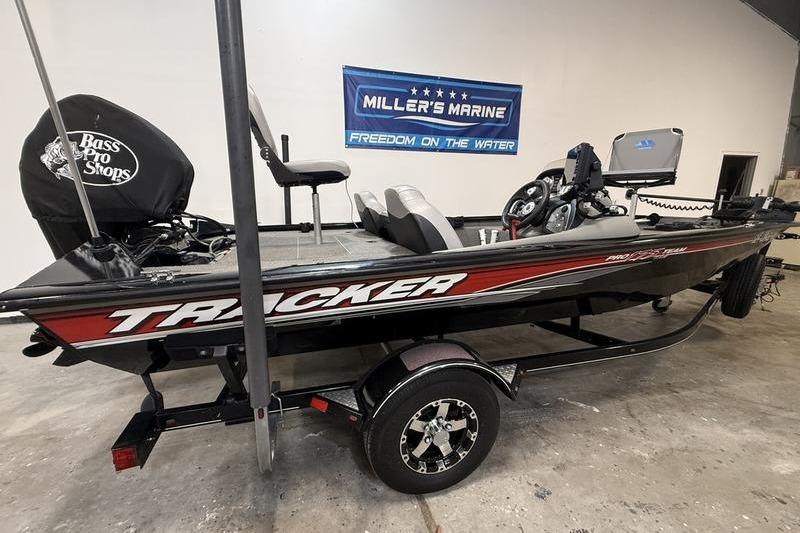2016 Tracker Pro Team 175 TXW fishing boat in showroom, featuring Bass Pro Shops motor.