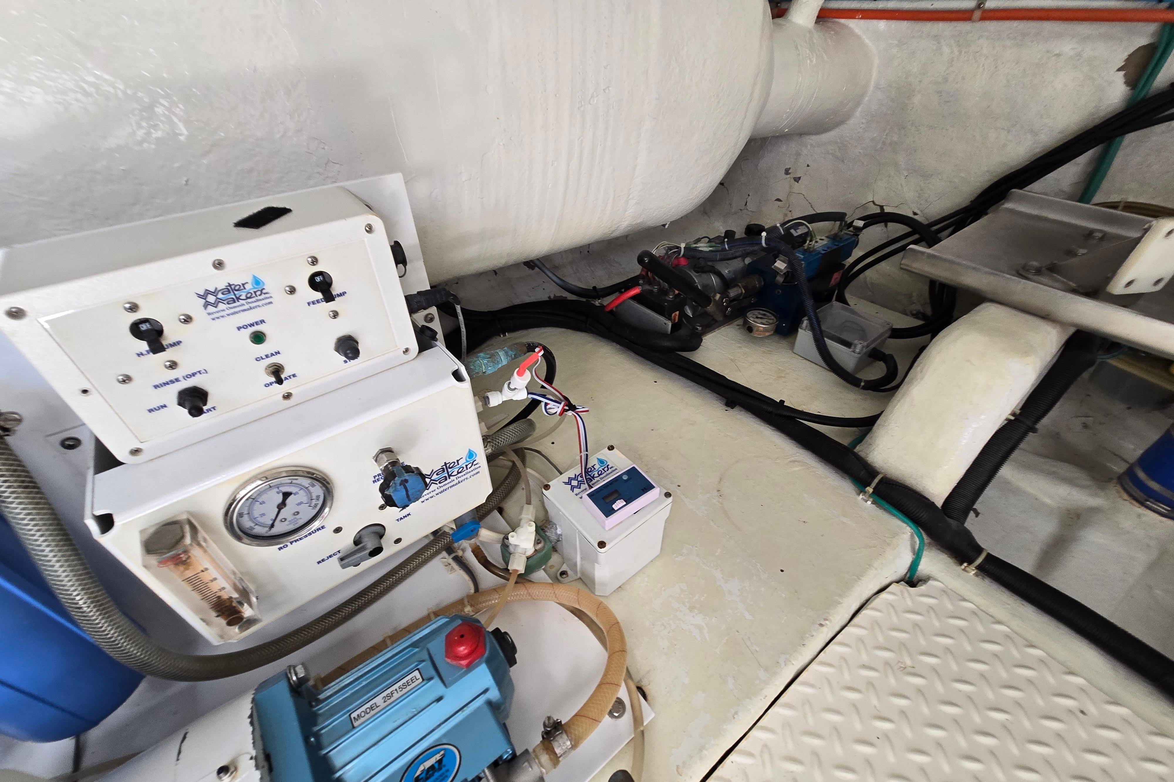 Engine room of 2004 Grand Harbour 58 yacht with watermaker system and control panel.