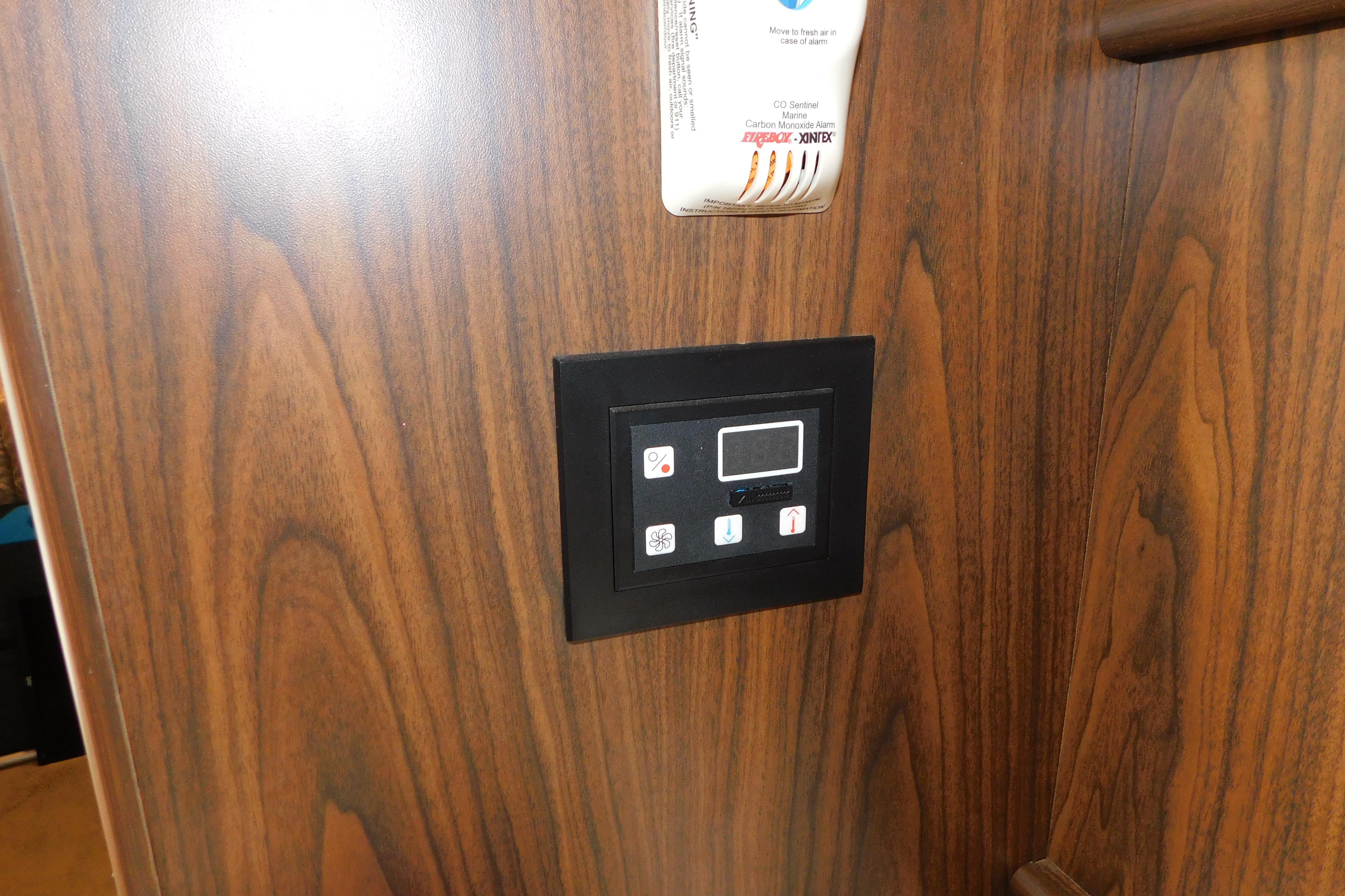 Control panel on wood interior of 2017 Rinker EX 320 boat.