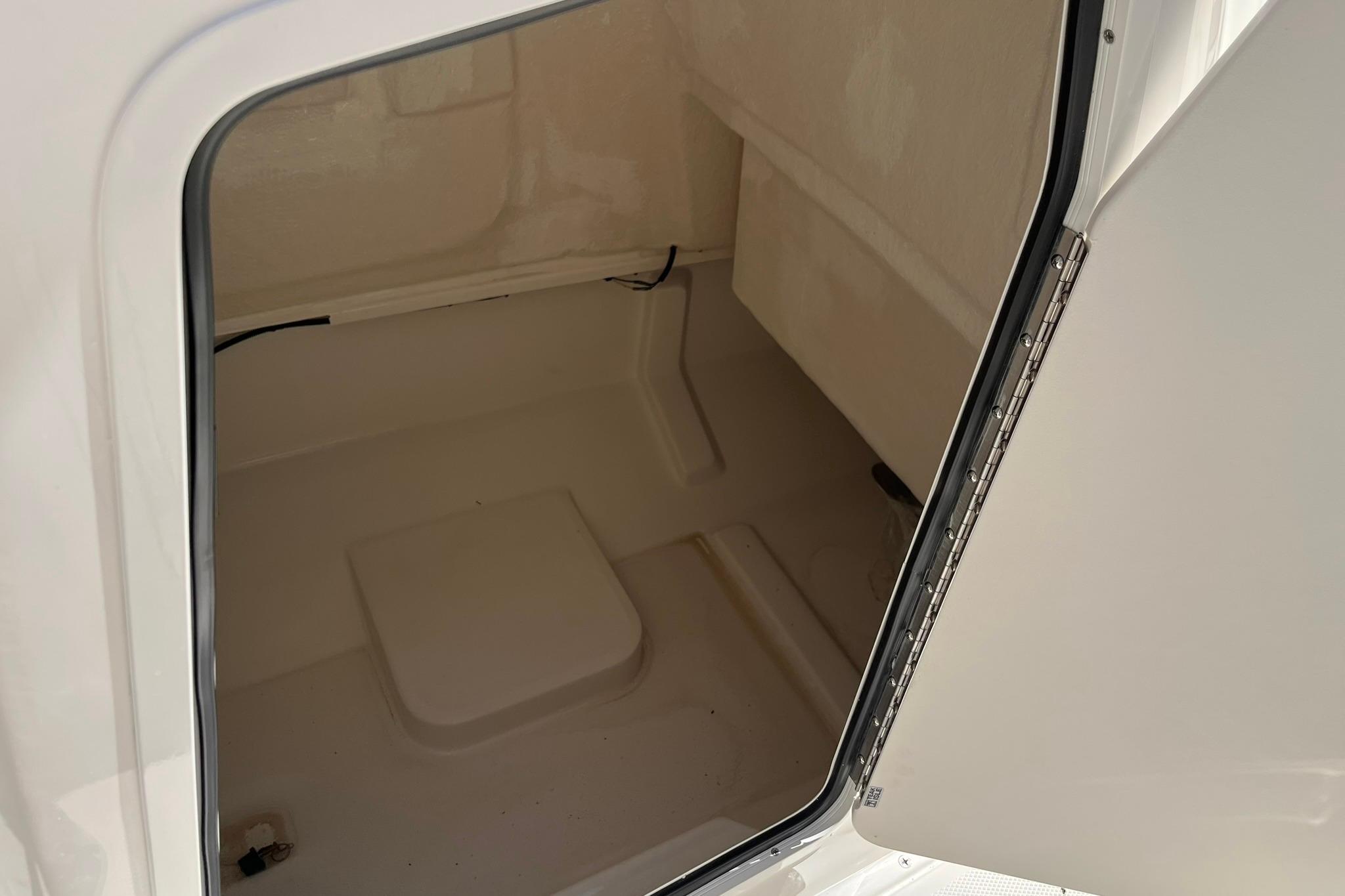 Storage compartment of 2026 Bayliner Trophy T22CC boat, open door view.
