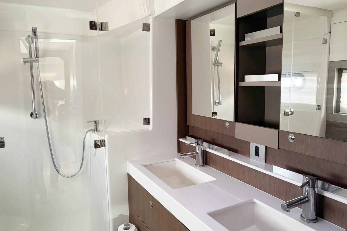 Modern bathroom interior on Bali 4.2 yacht, featuring dual sinks and a sleek shower, 2022 model.