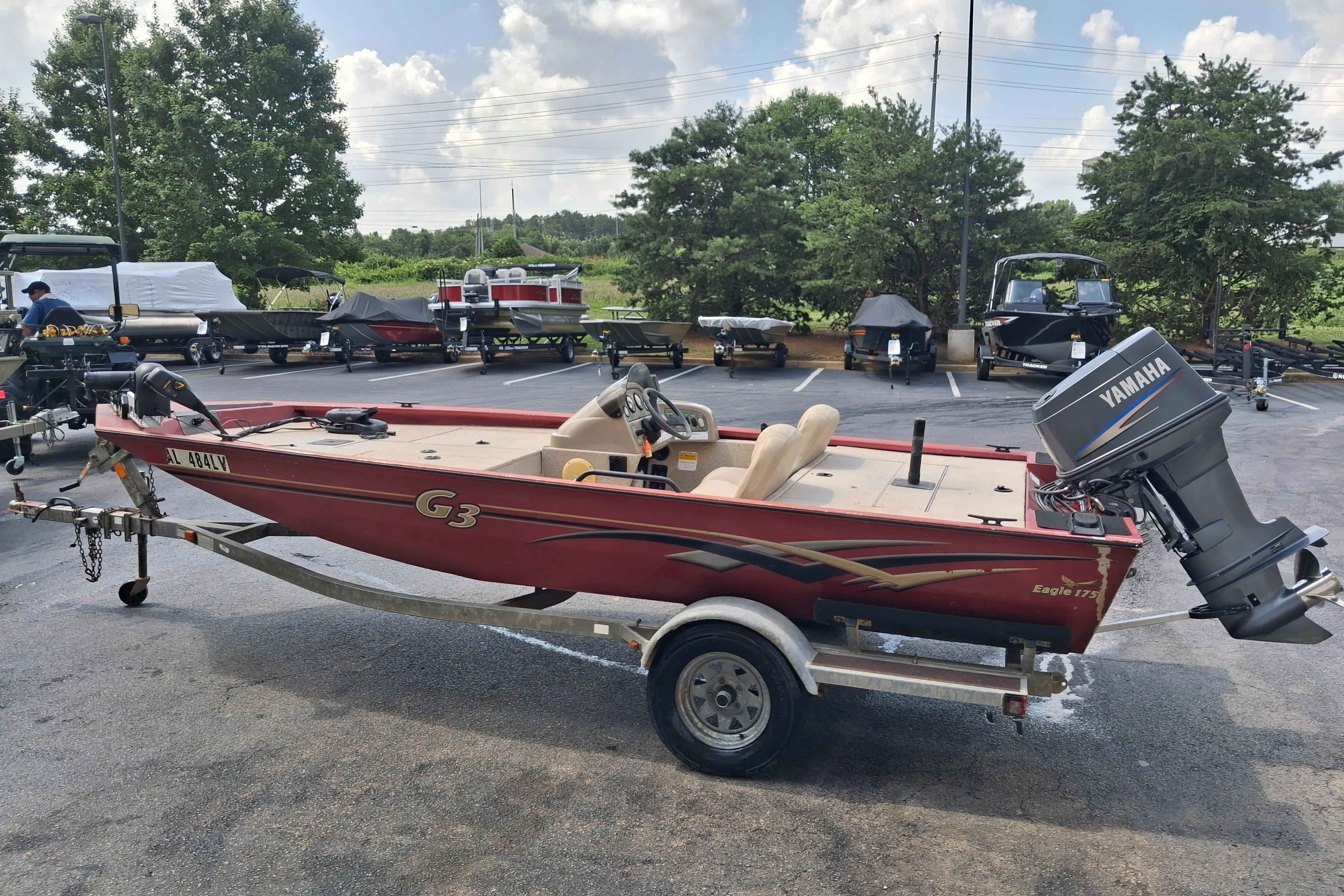 Red 2008 G3 Eagle 175 boat with Yamaha motor on trailer in parking lot.