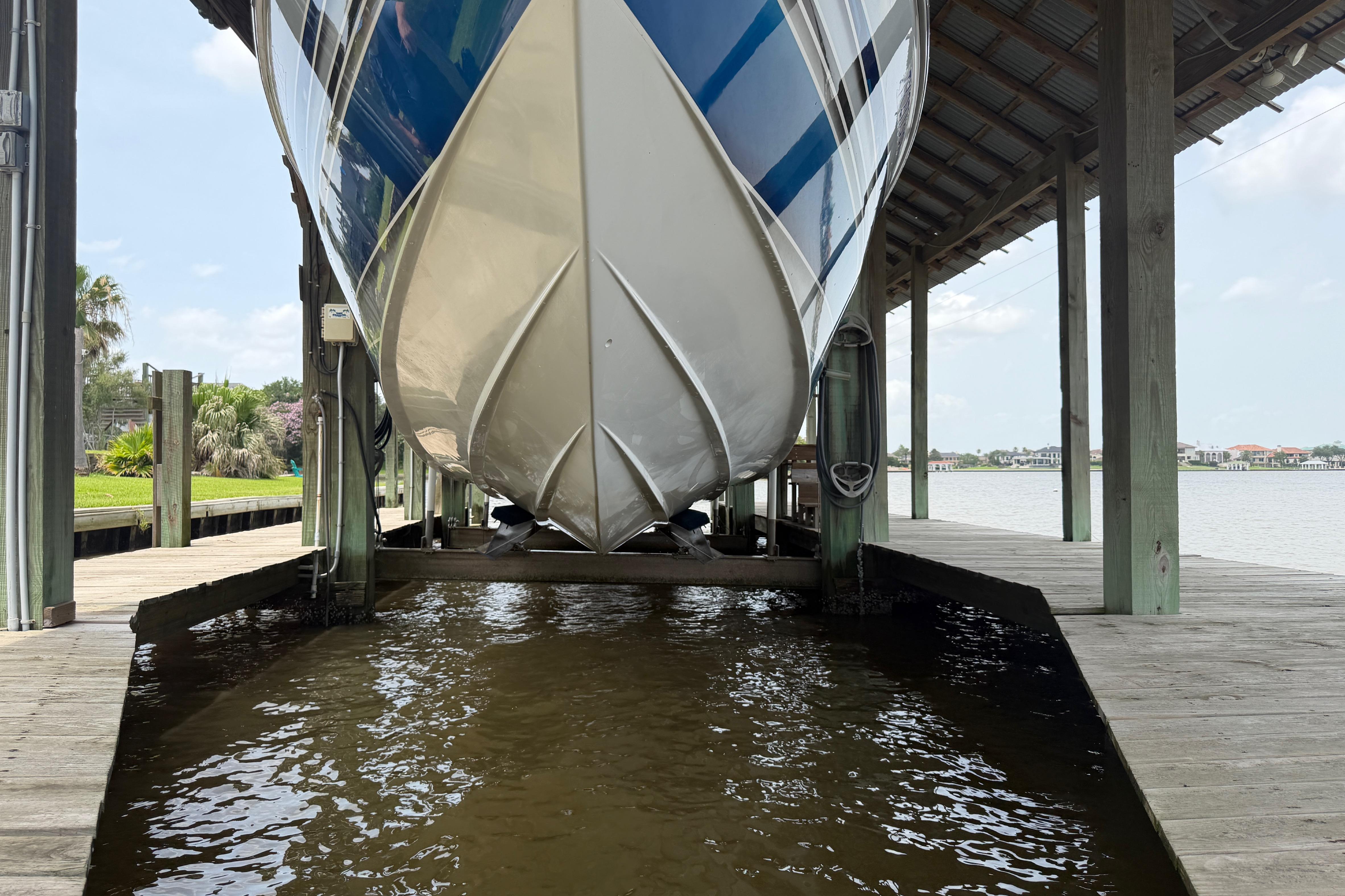 2013 Nor-Tech 477 SPX Vee Bottom boat docked in a covered marina.