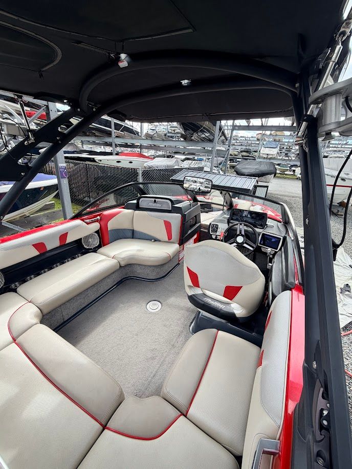 Interior of a 2016 Malibu Wakesetter 20 VTX boat with red accents.