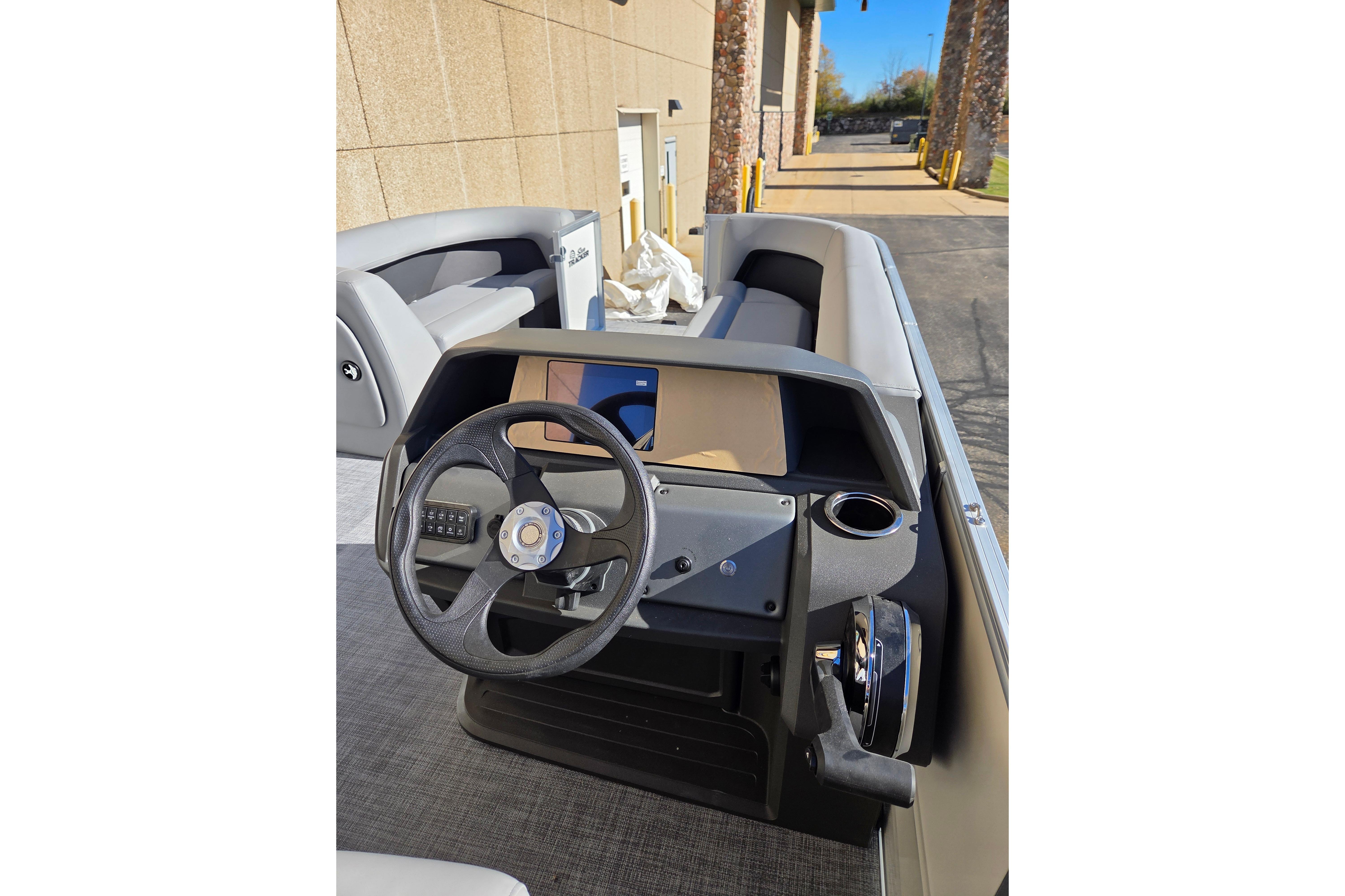2026 Sun Tracker Party Barge 18 DLX steering console with modern design and controls.