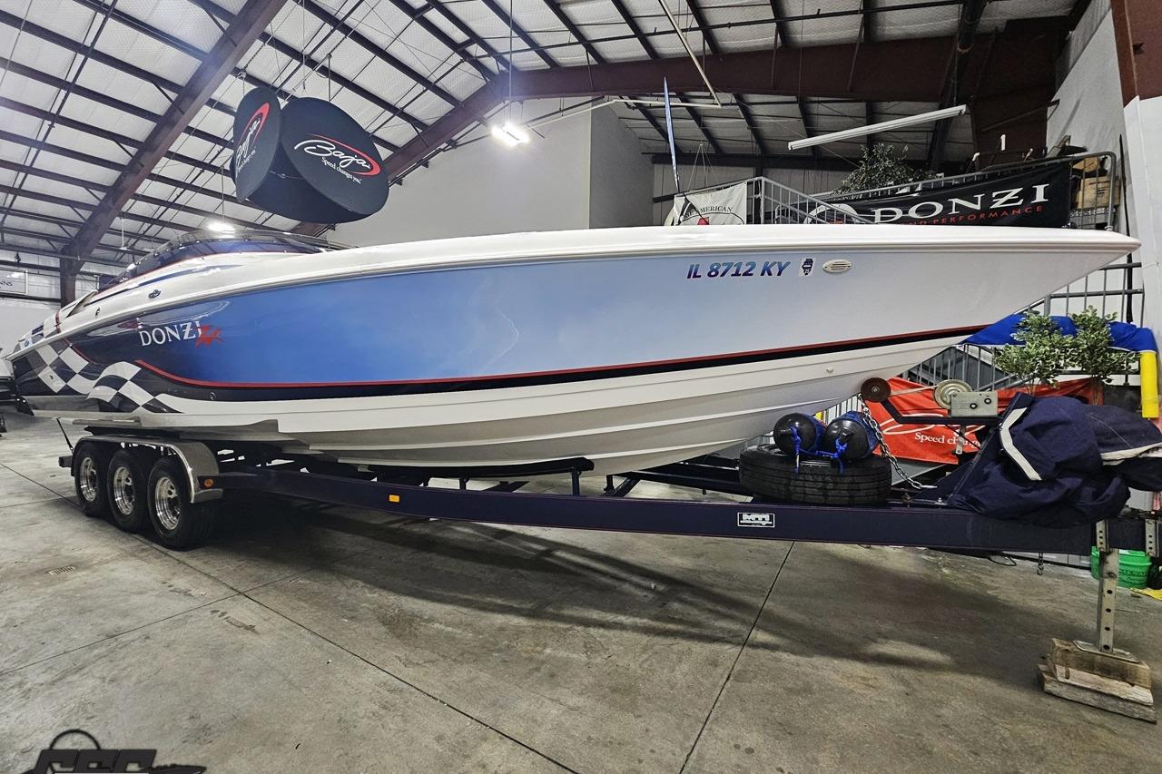 2000 Donzi 33 ZX speedboat on trailer in indoor storage facility.