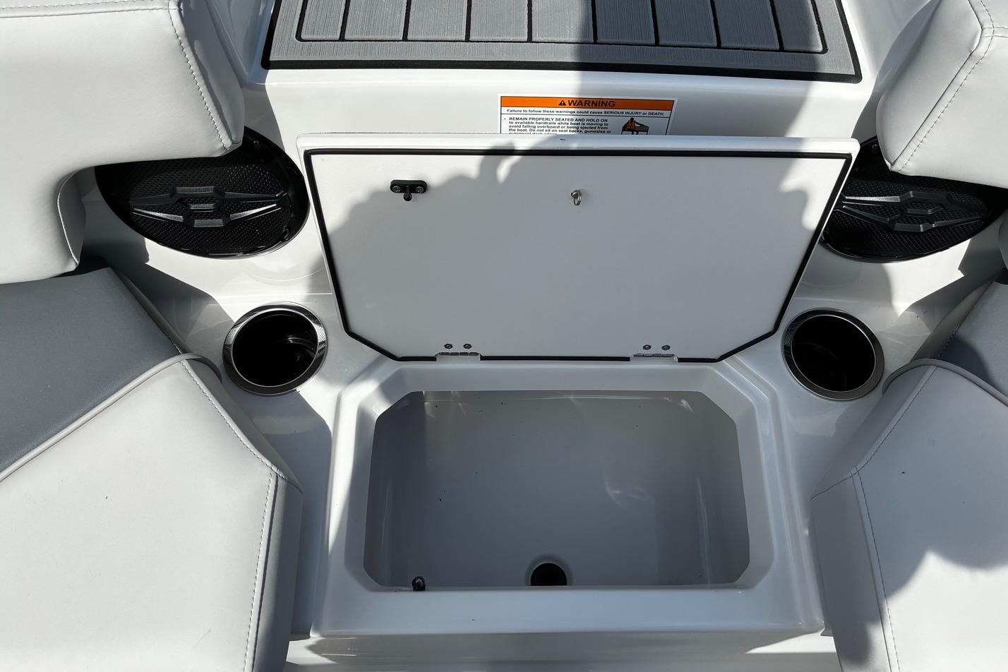 2026 Starcraft SVX 191 OB boat interior with storage compartment and cup holders.