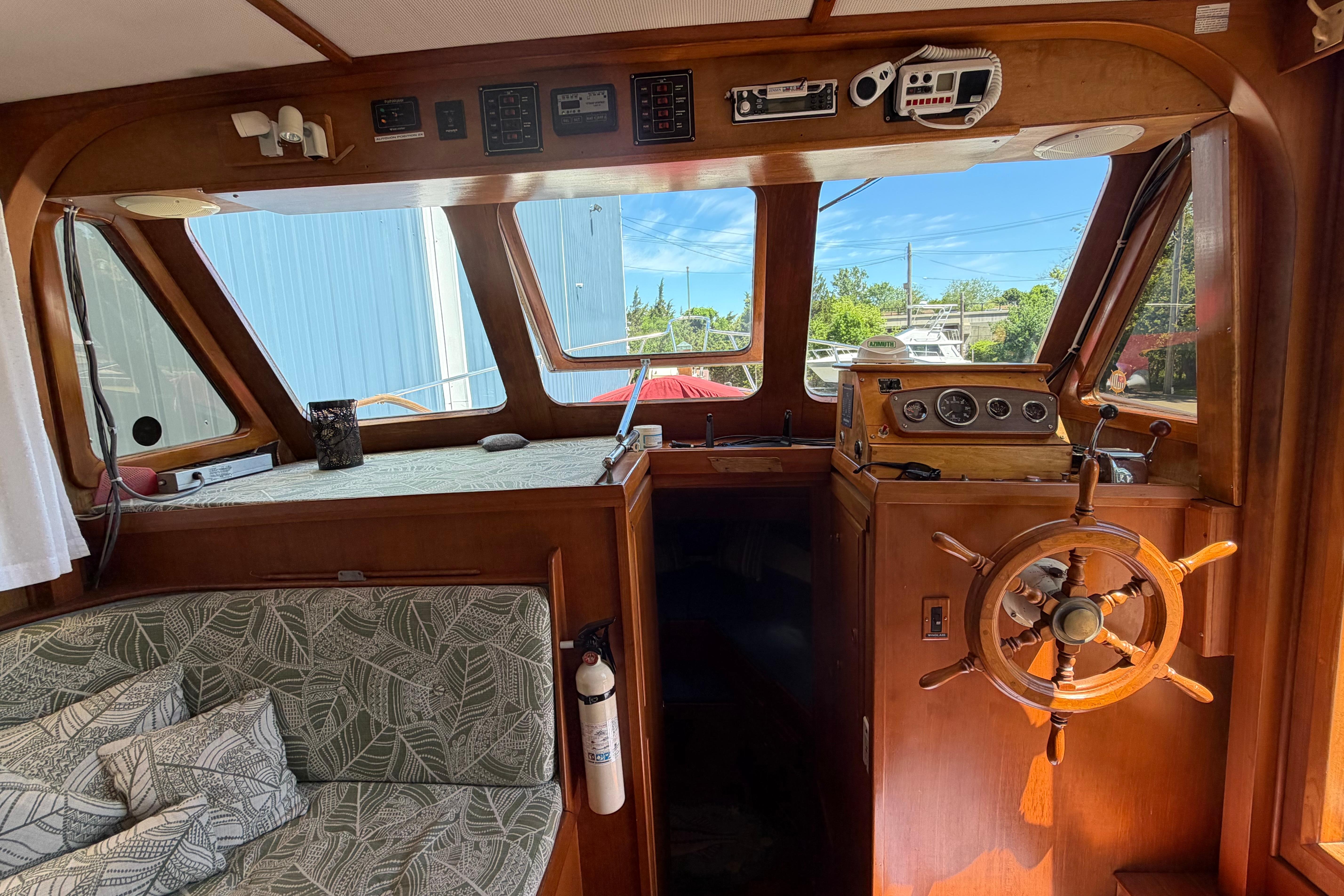 Interior of 1987 Marine Trader 36 boat with wooden helm and nautical instruments.