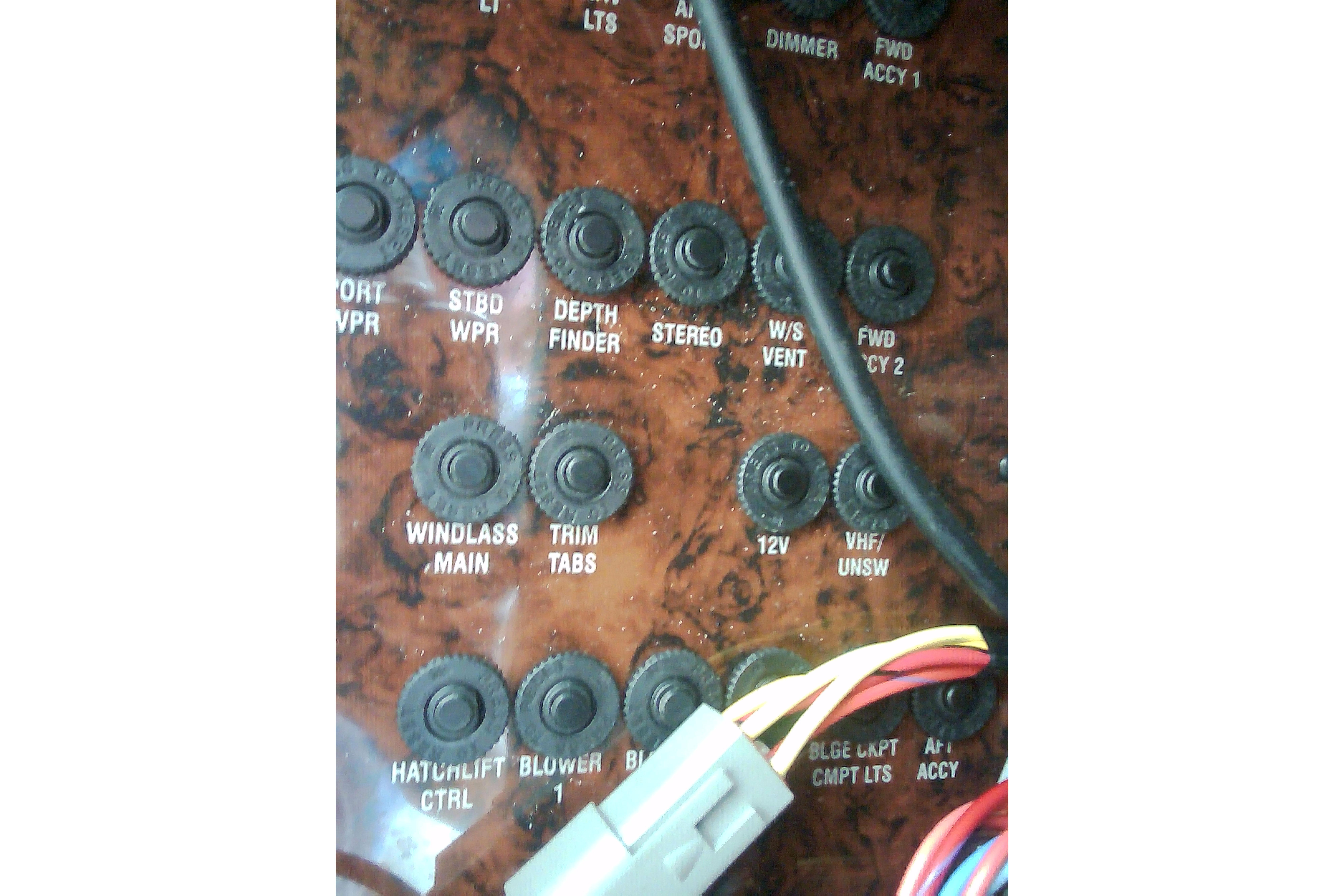 Control panel of a 2005 Sea Ray 300 Sundancer boat with labeled switches and wiring.