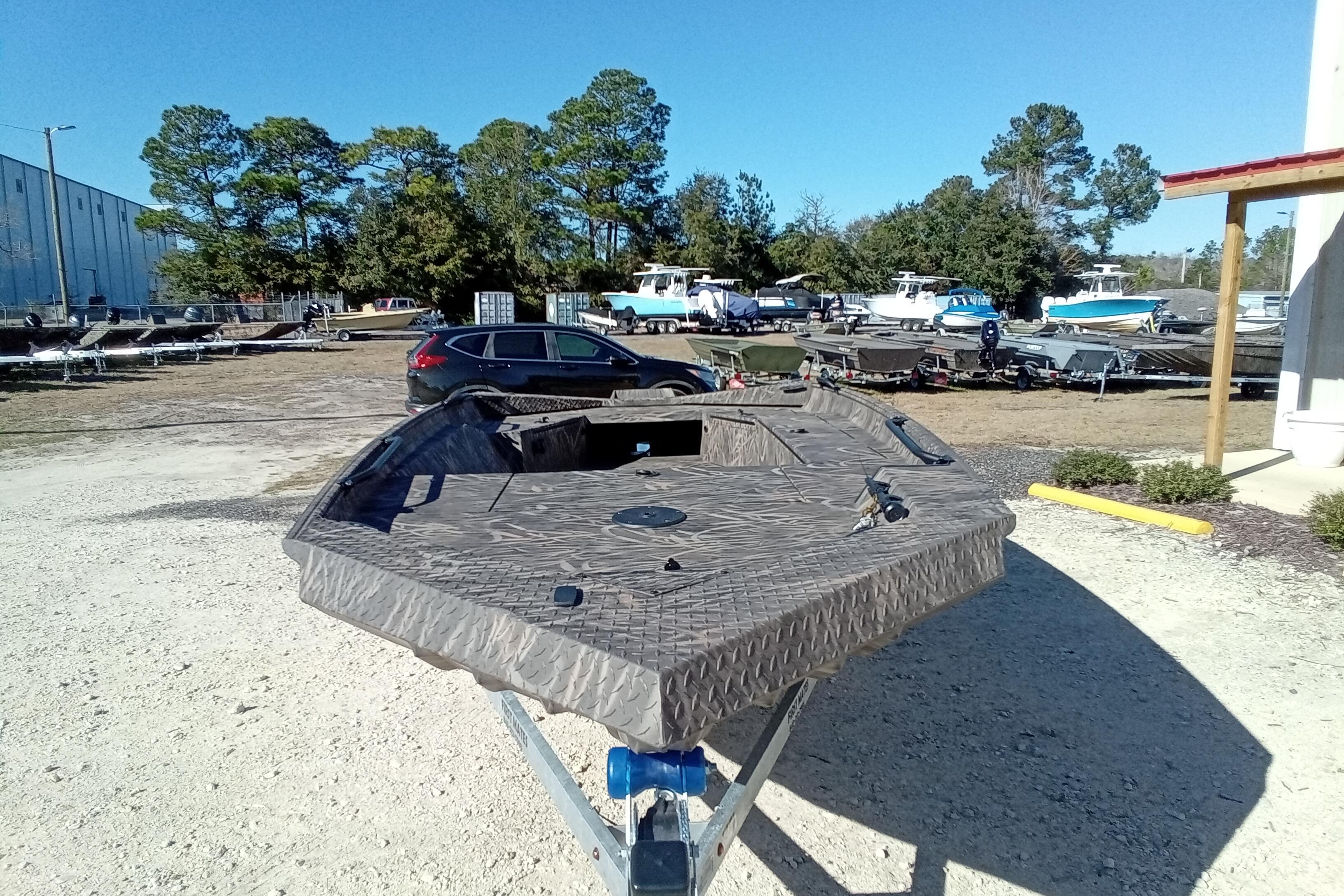2026 Alweld 1756 Invader boat on trailer in outdoor lot.