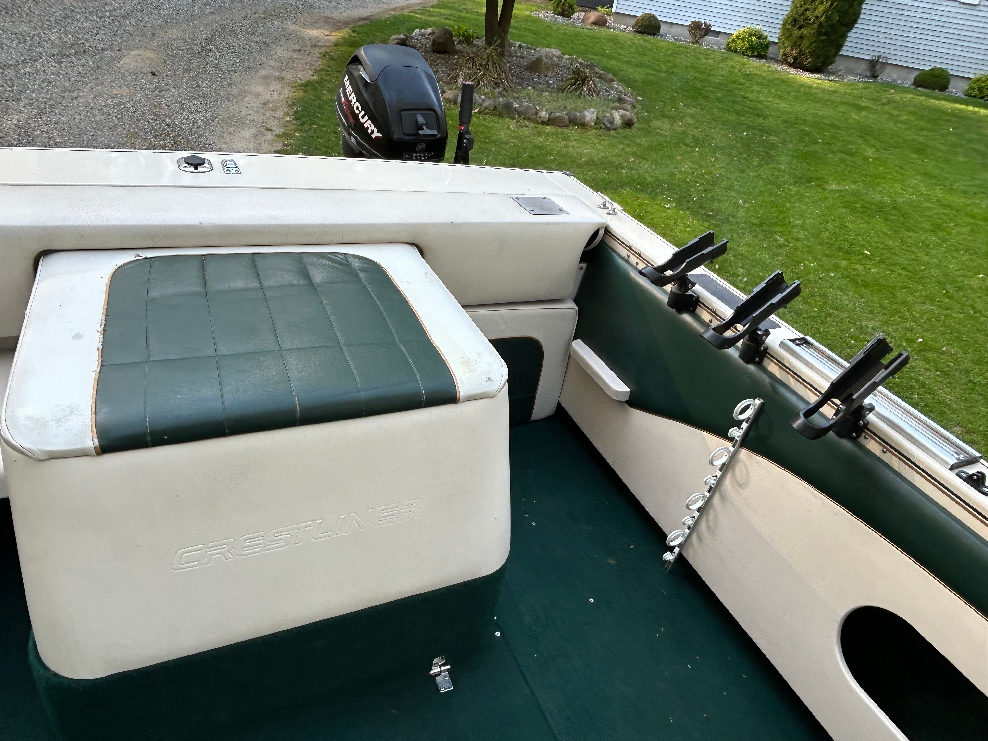 Interior of a 1997 Crestliner 2050 Sportfish boat with fishing rod holders.