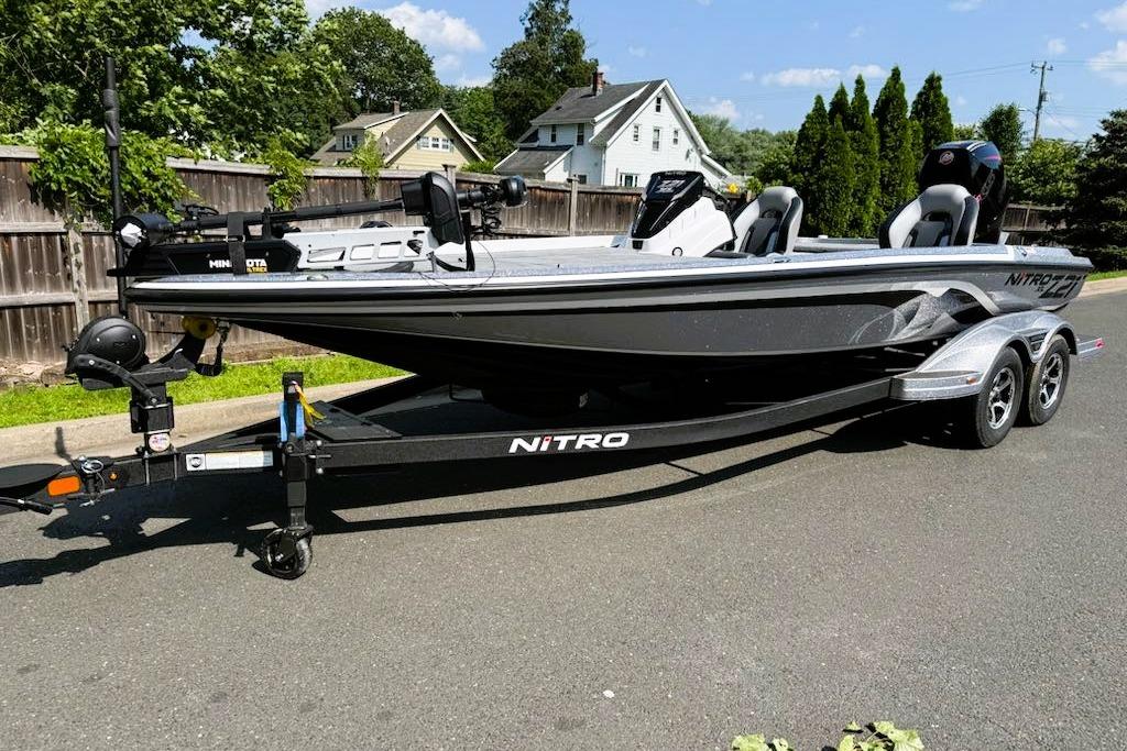 2025 Nitro Z21 XL Pro boat on trailer, parked on street, sunny day.