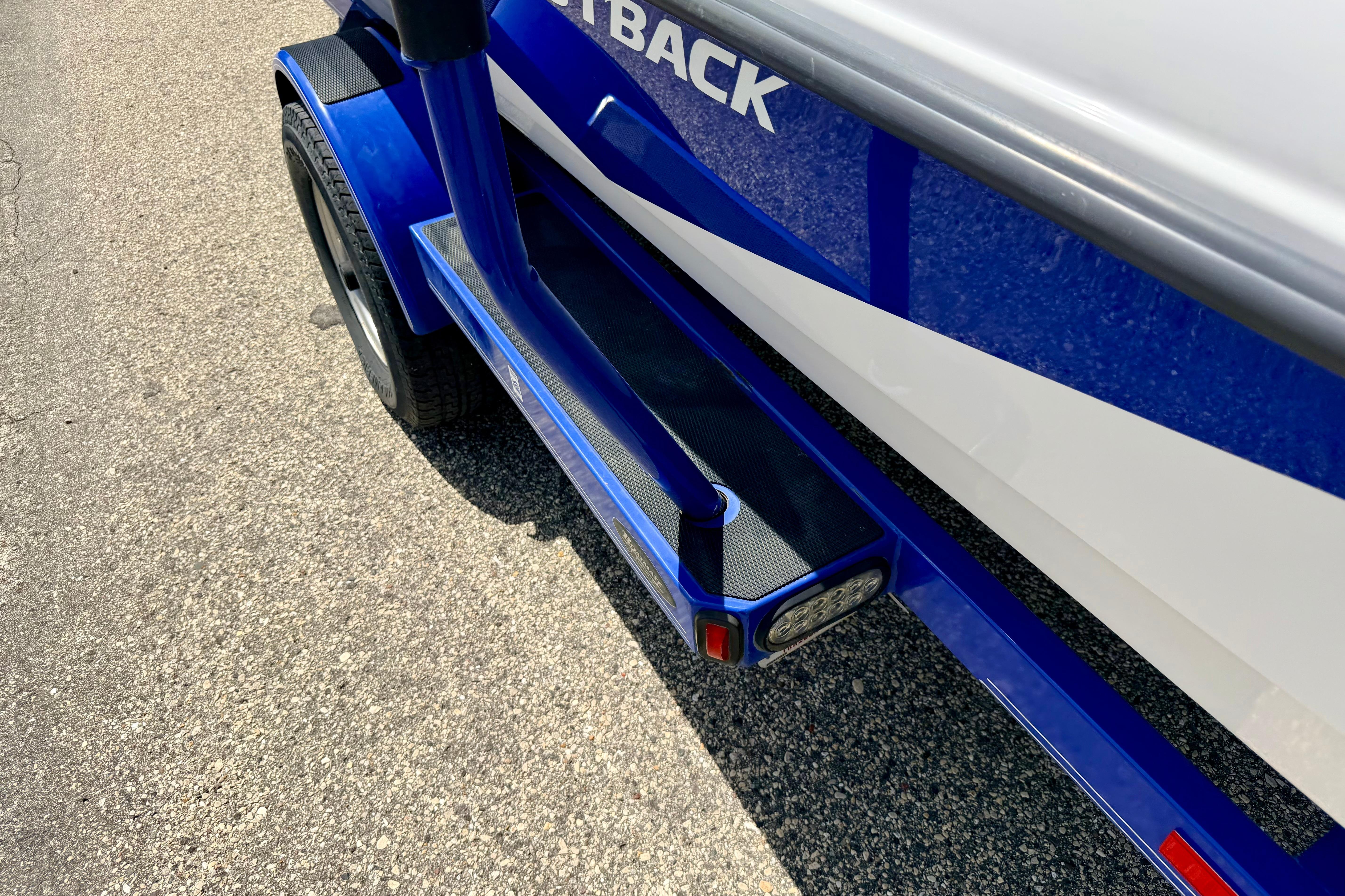 2008 Moomba Outback V boat trailer, blue and white, on asphalt surface.