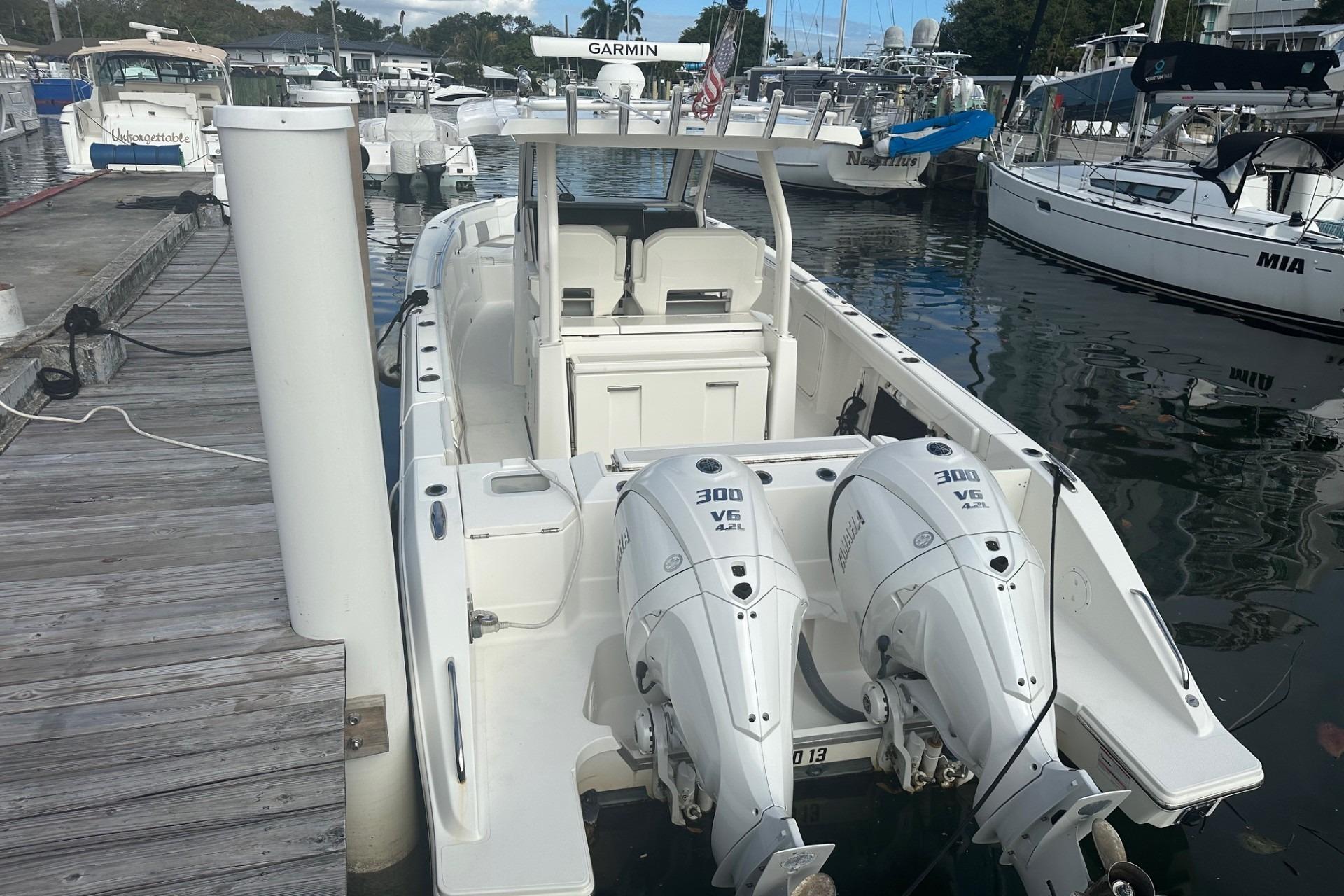 2023 Pursuit S 328 Sport boat docked with twin Yamaha 300 V6 engines.