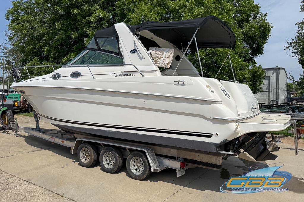 1999 Sea Ray 290 Sundancer boat on trailer, featuring sleek design and canopy.