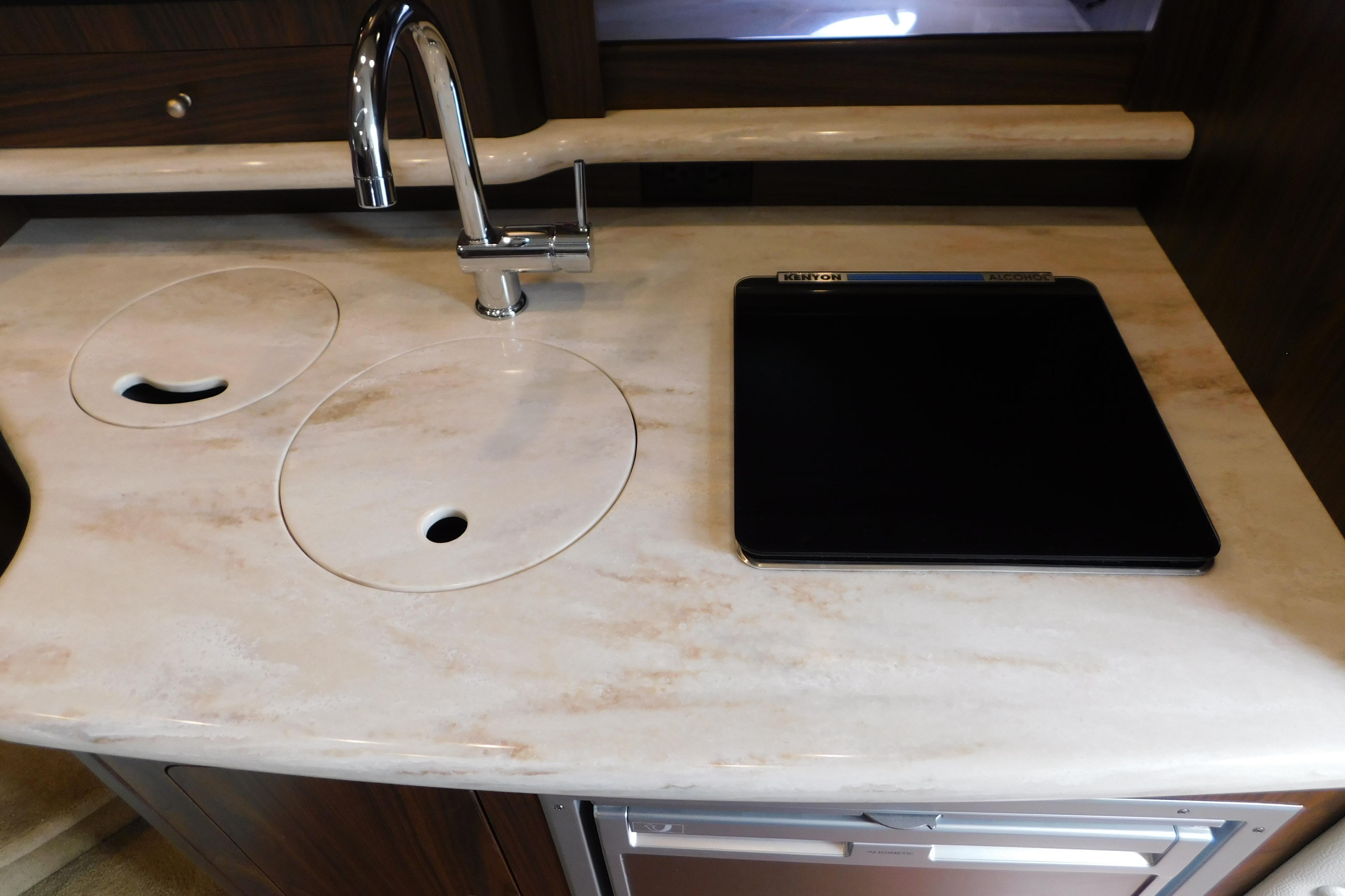 2017 Rinker EX 320 boat kitchen with sink and stovetop.