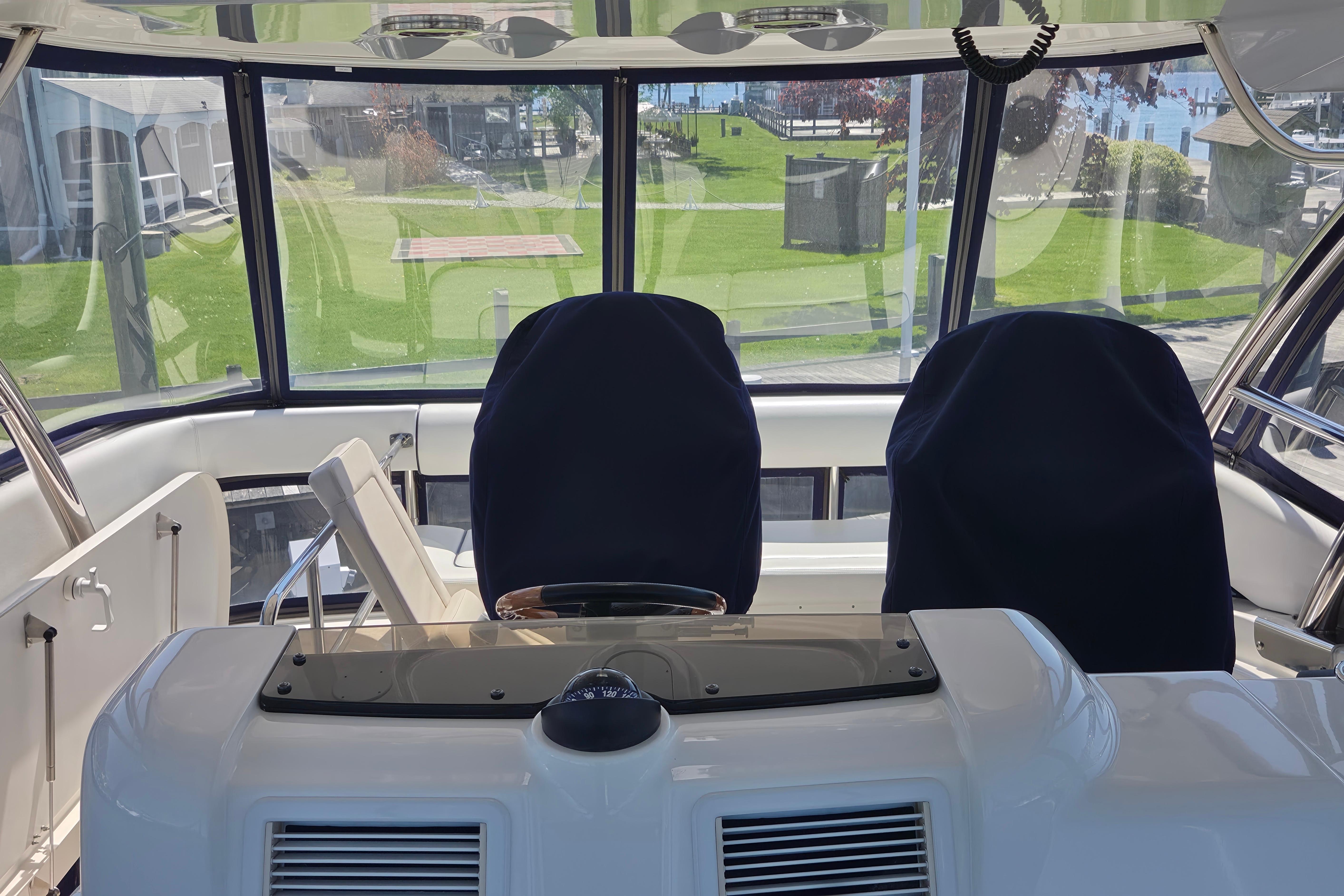 2007 Sea Ray 580 Sedan Bridge helm with covered seats and panoramic windows.