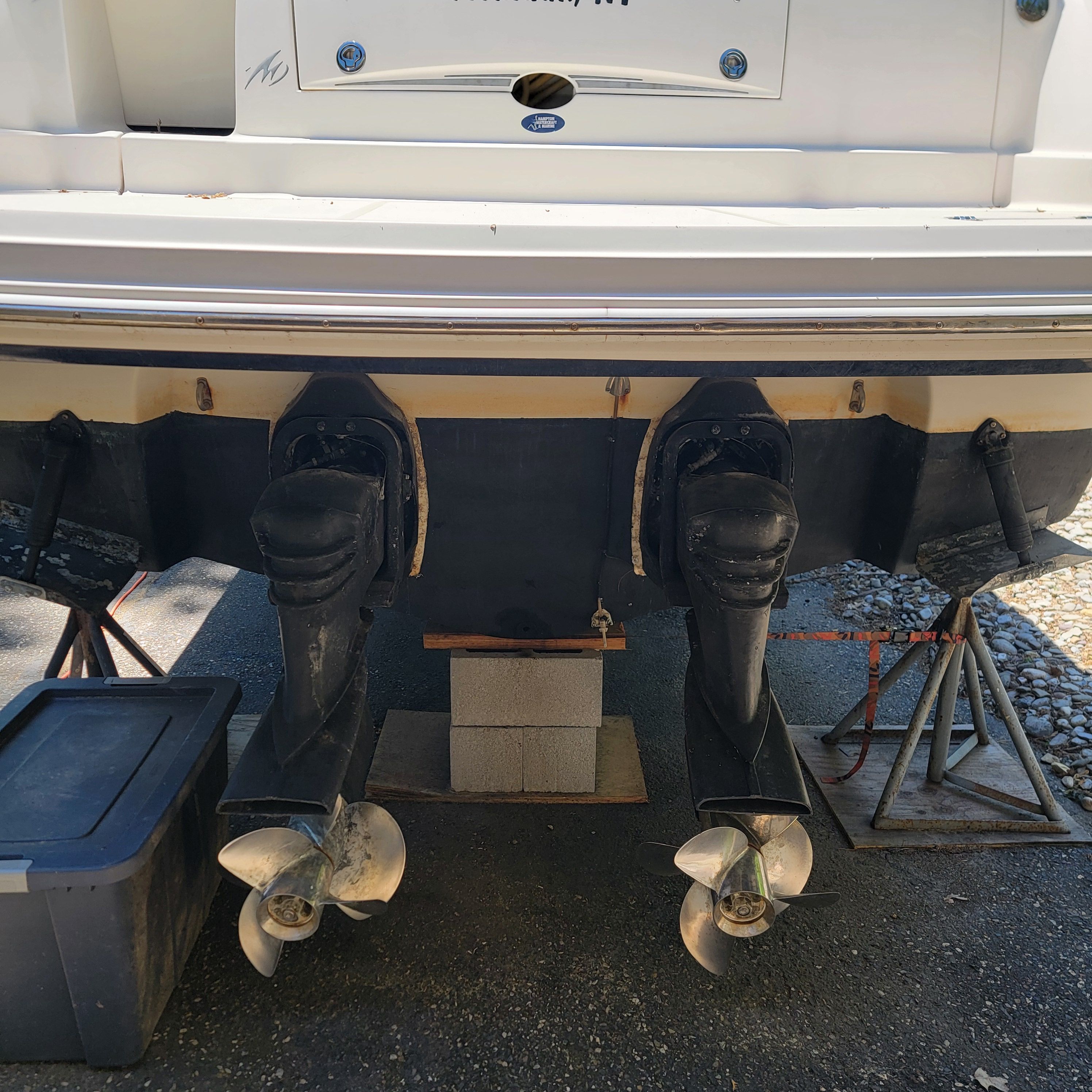 Two boat engines with propellers on a trailer.