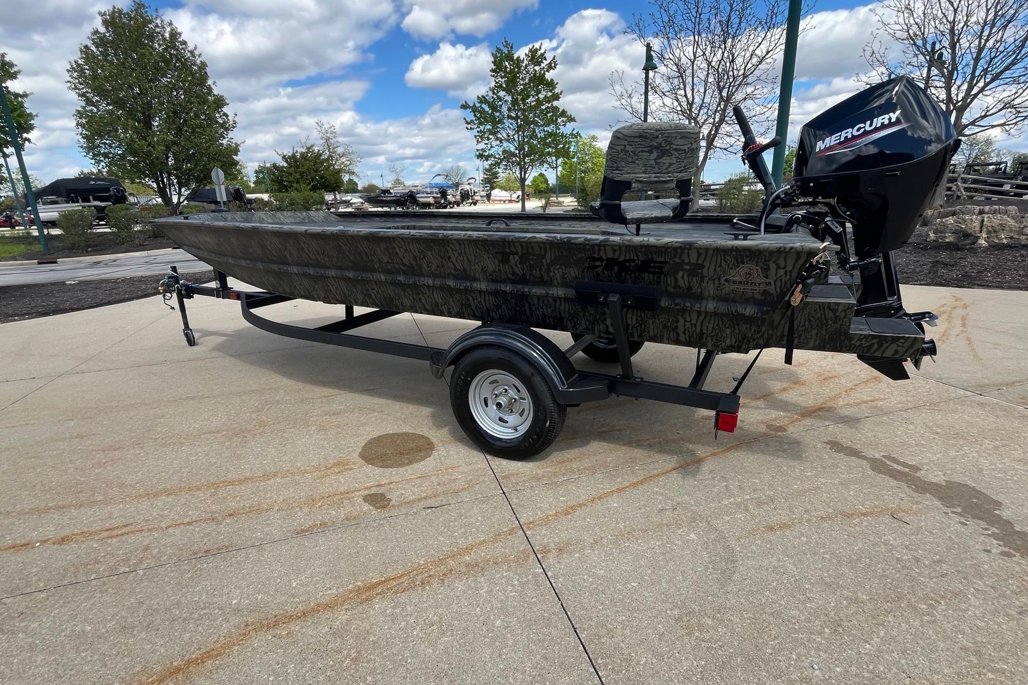 2026 Tracker Grizzly 1654 T Sportsman boat on trailer, outdoors under cloudy sky.