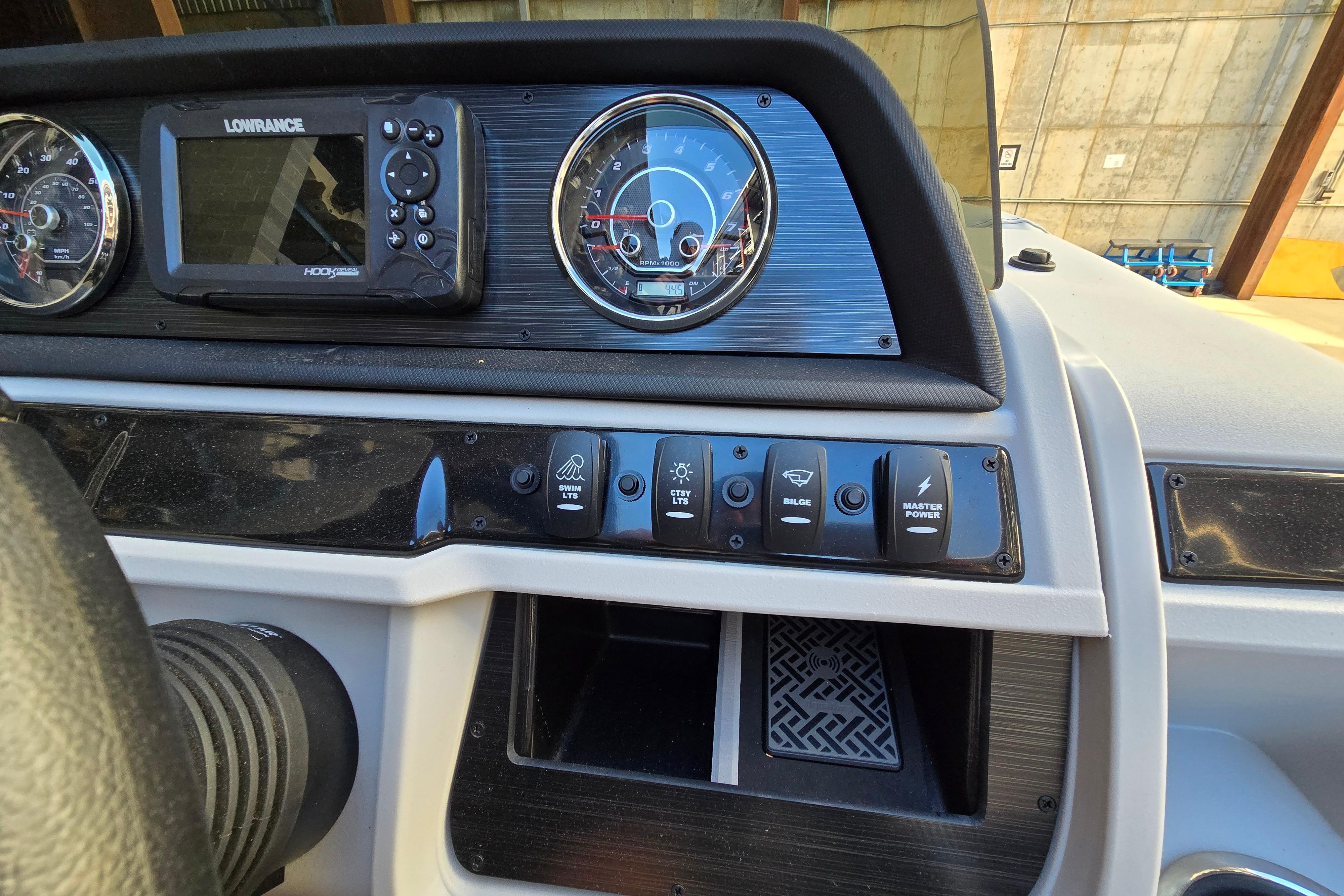 Dashboard of 2024 Godfrey Sweetwater 2486 SB with gauges and control switches.