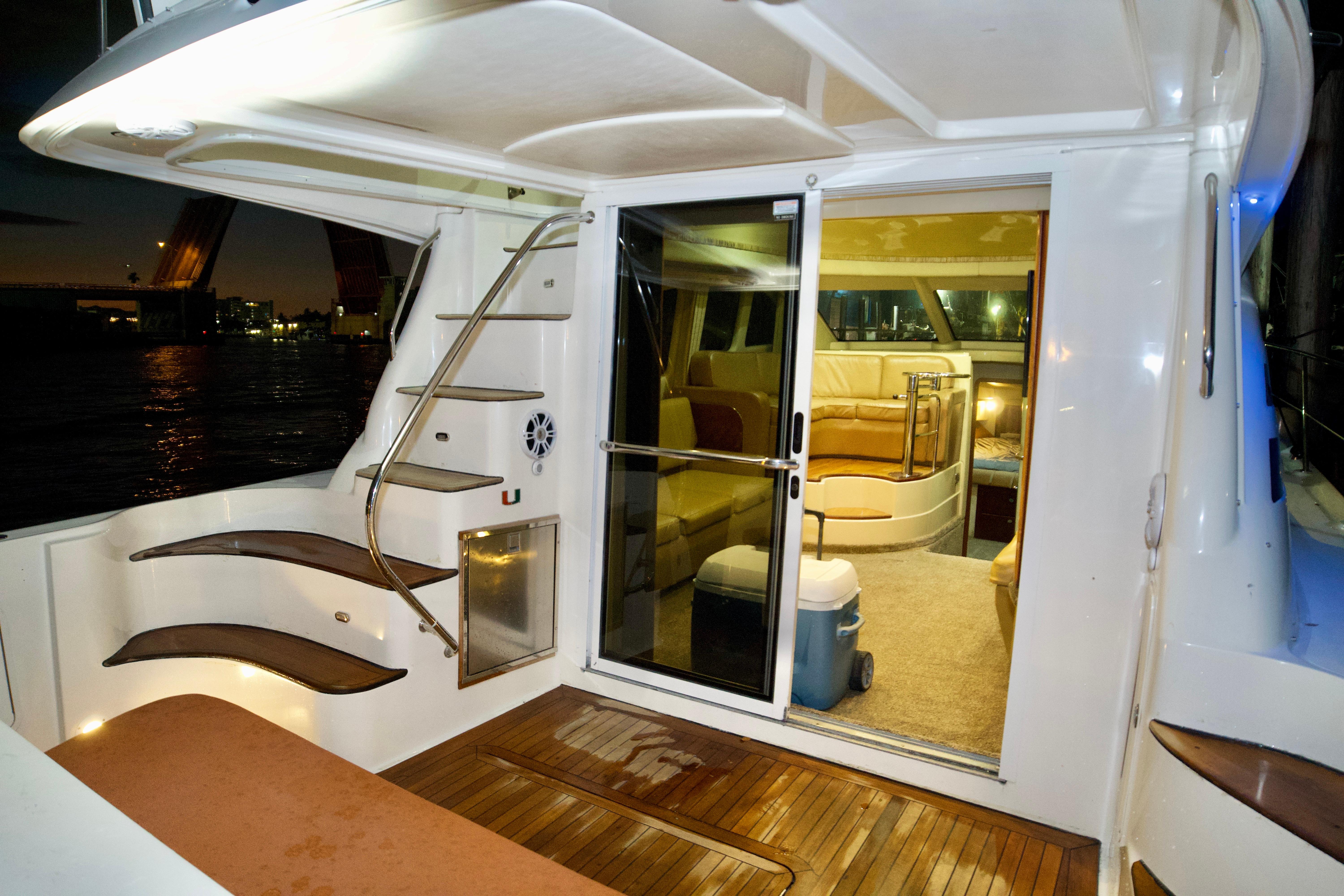 2006 Sea Ray 44 Sedan Bridge yacht interior with wooden deck and modern seating.