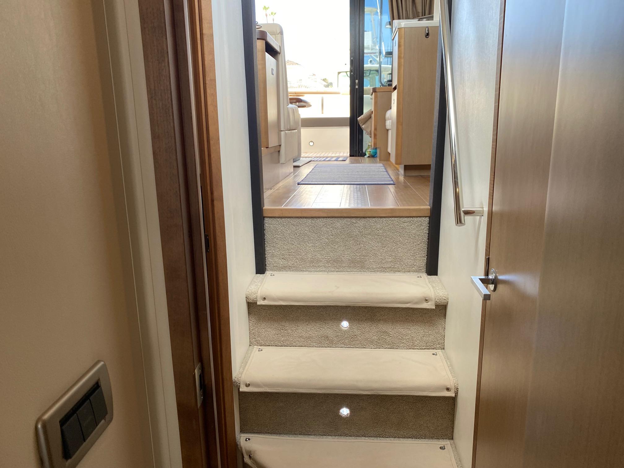 Interior stairs of 2018 Sea Ray 400 Fly yacht, leading to upper deck.