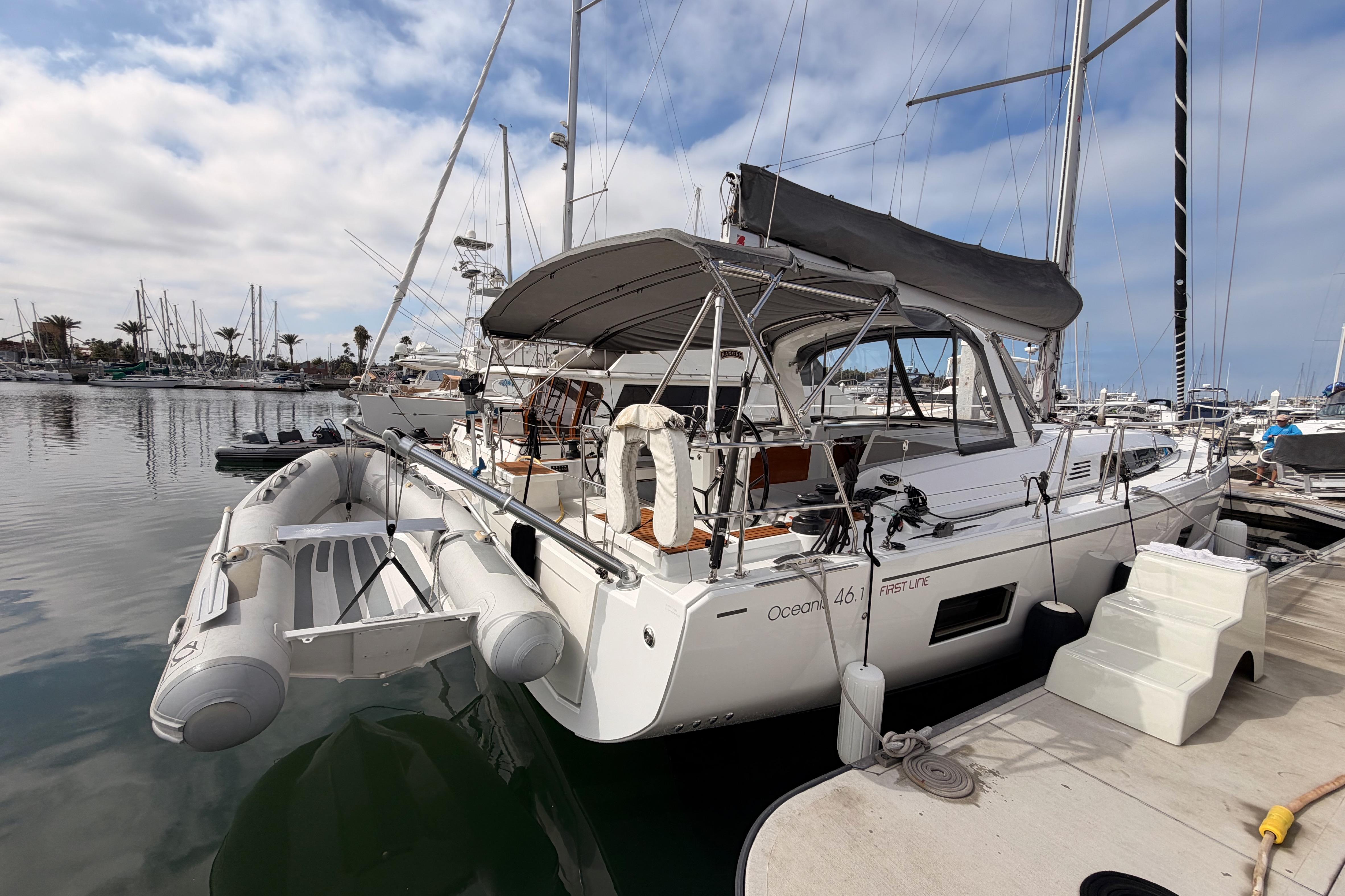 2020 Beneteau Oceanis 46.1 yacht docked at marina, featuring inflatable dinghy.