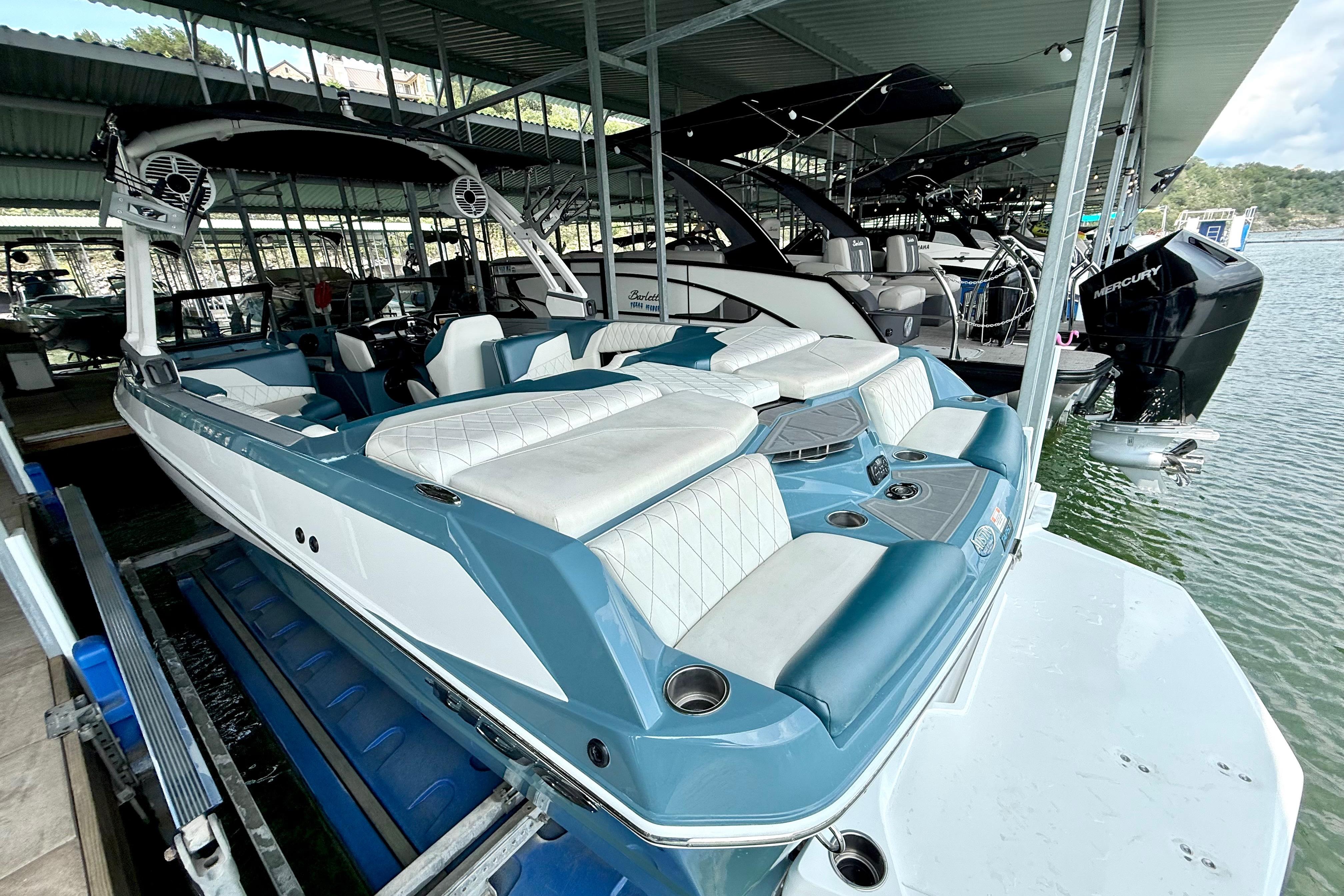 2021 Tige Z3 boat docked in a marina, featuring sleek design and comfortable seating.
