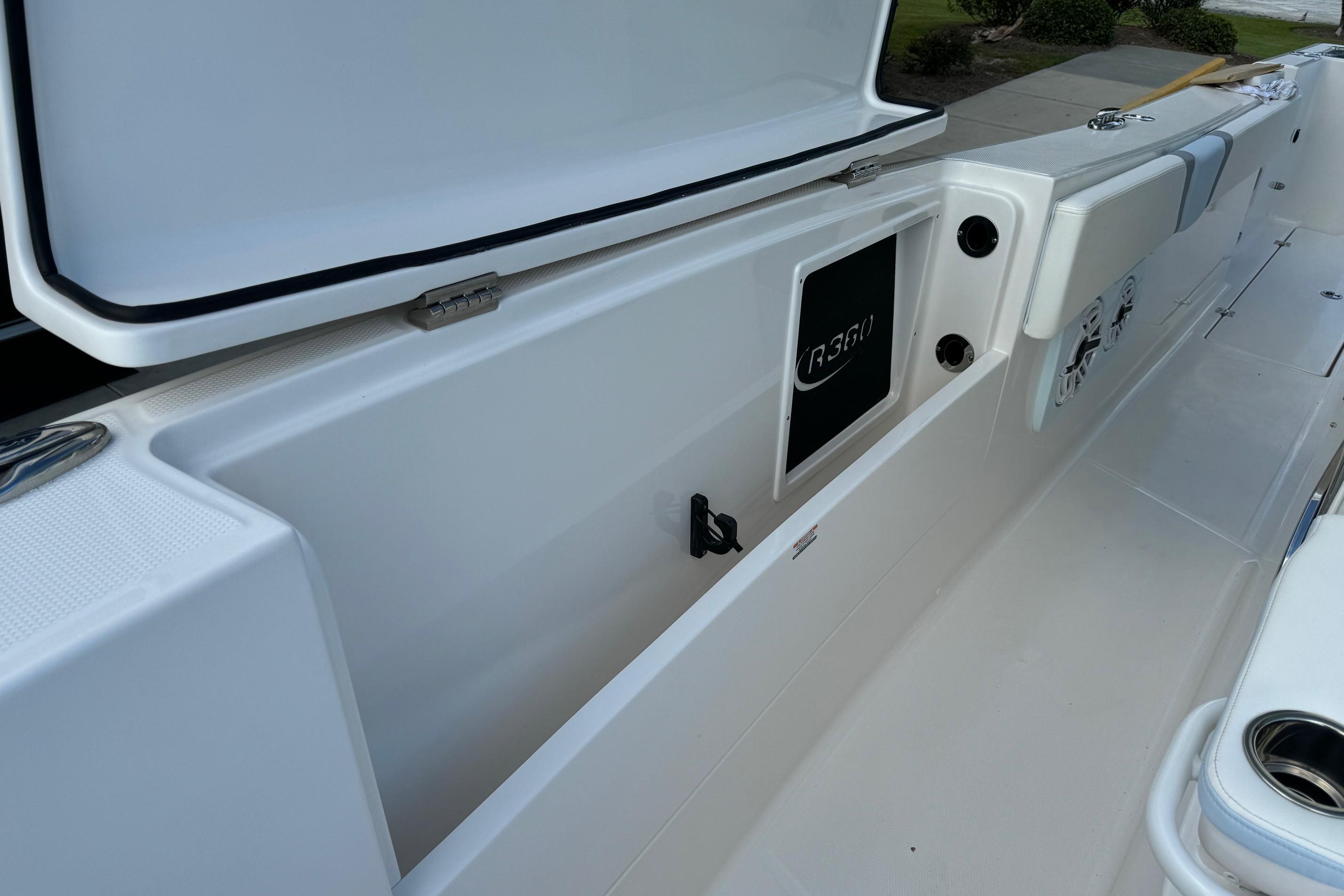 2025 Robalo R360 Center Console boat interior with open storage compartment.