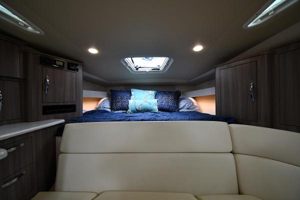 2021 Regal 35 Sport Coupe interior cabin with bed, cushions, and ambient lighting.