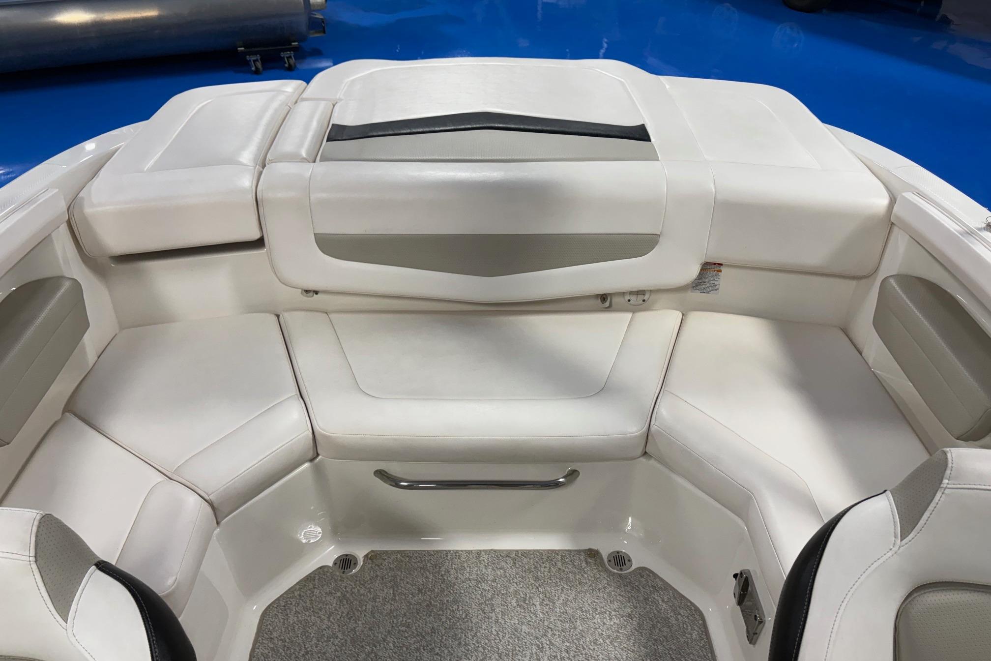 Interior seating of a 2011 Chaparral 216 SSi boat, featuring white upholstery.